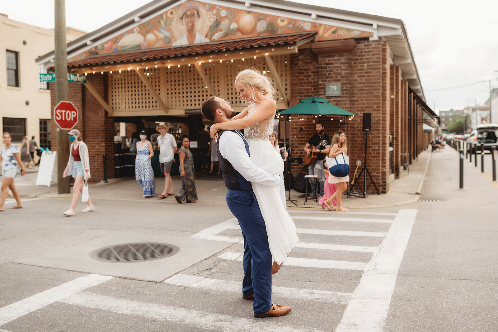 Bride and Groom dance in the street in front of the city market after their Micro-Wedding Ceremony in Charleston, SC.