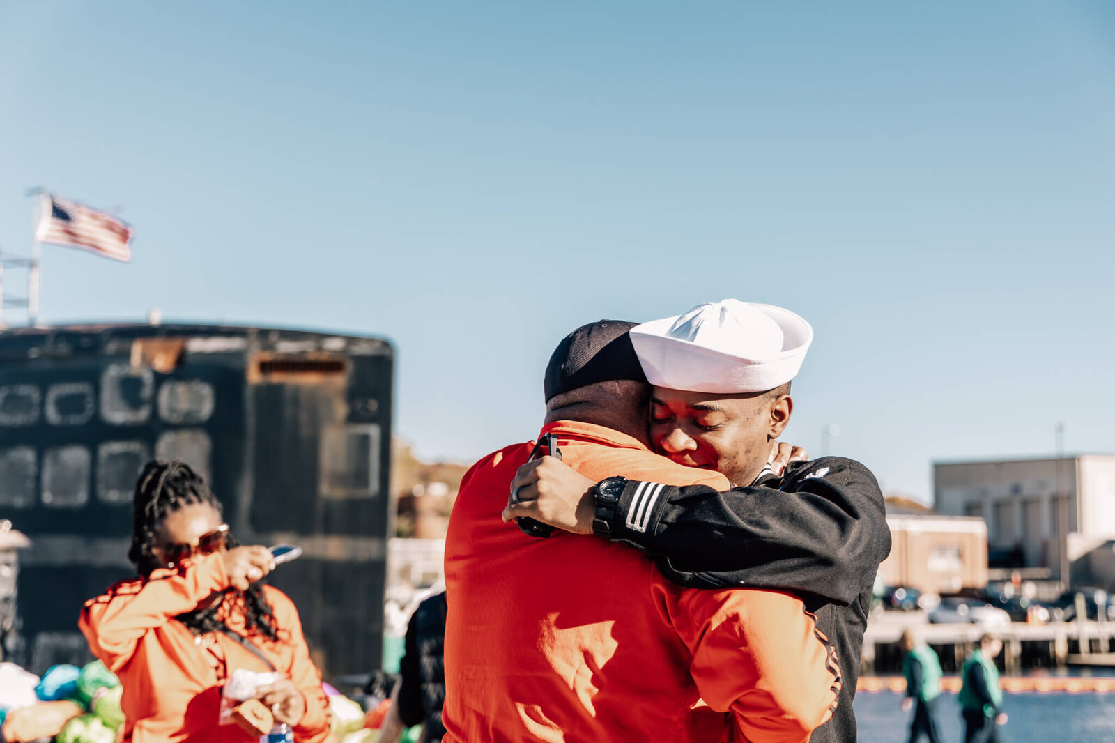 Navy Sailor embraces family member on pier at USS North Dakota homecoming at SUBASE New London in Groton Connecticut.