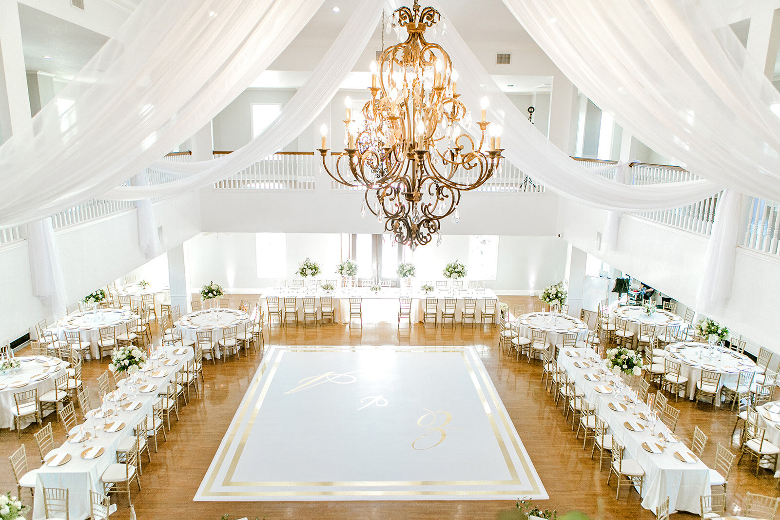 The ballroom set up for a reception with a custom carpet.