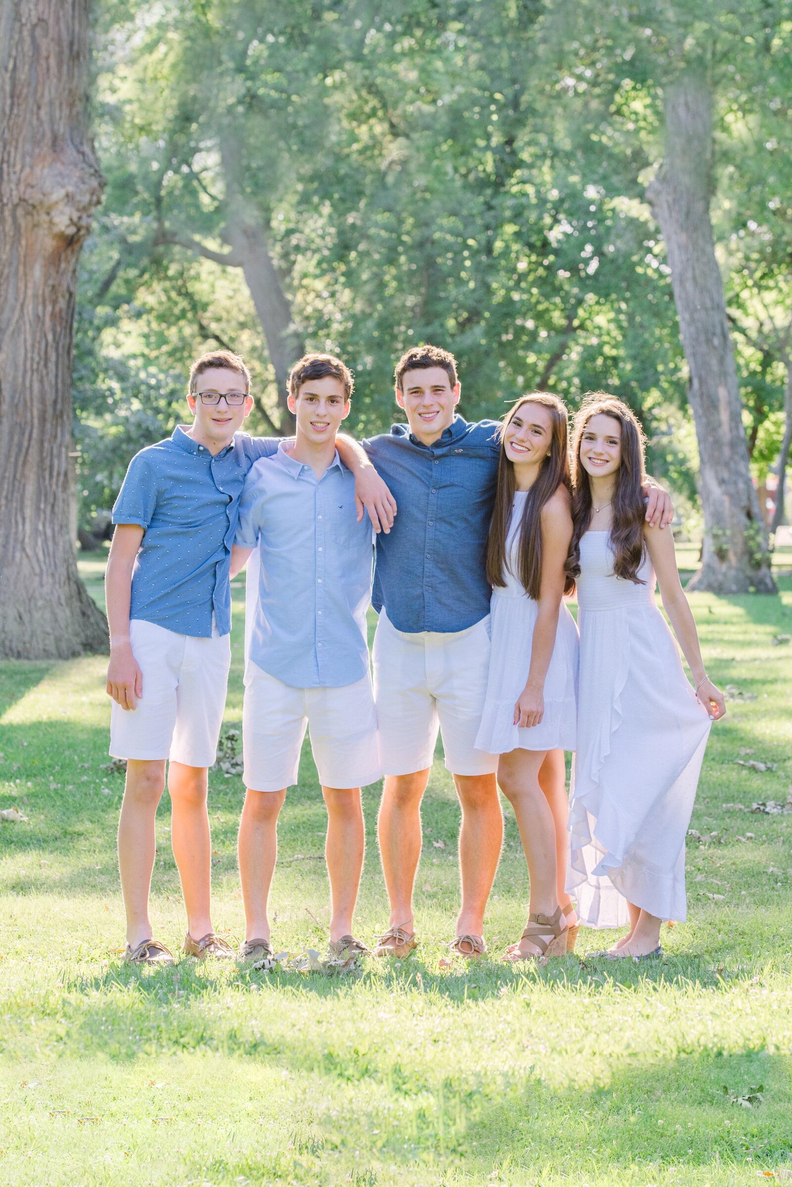 Five teenage siblings standing for a family photo in River Forest, IL by Chicago Family Photographer Kristen Hazelton