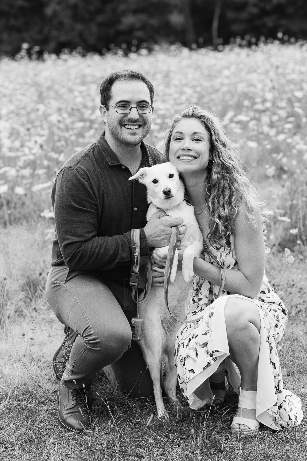 couple portrait in meadow with dog