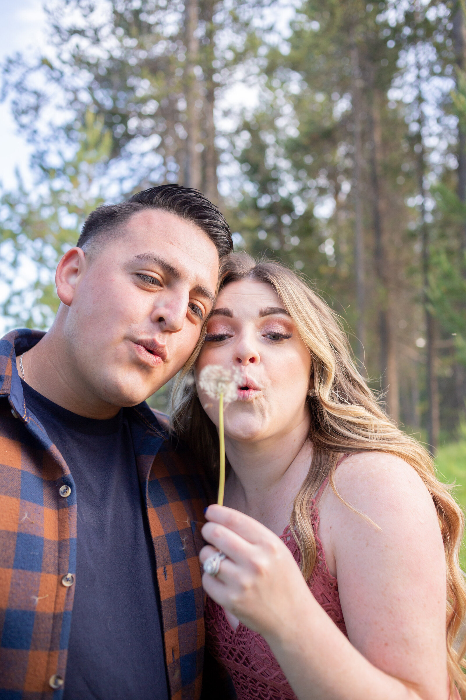Seattle Wedding Photographer captures adventurous couple making a wish on a dandelion