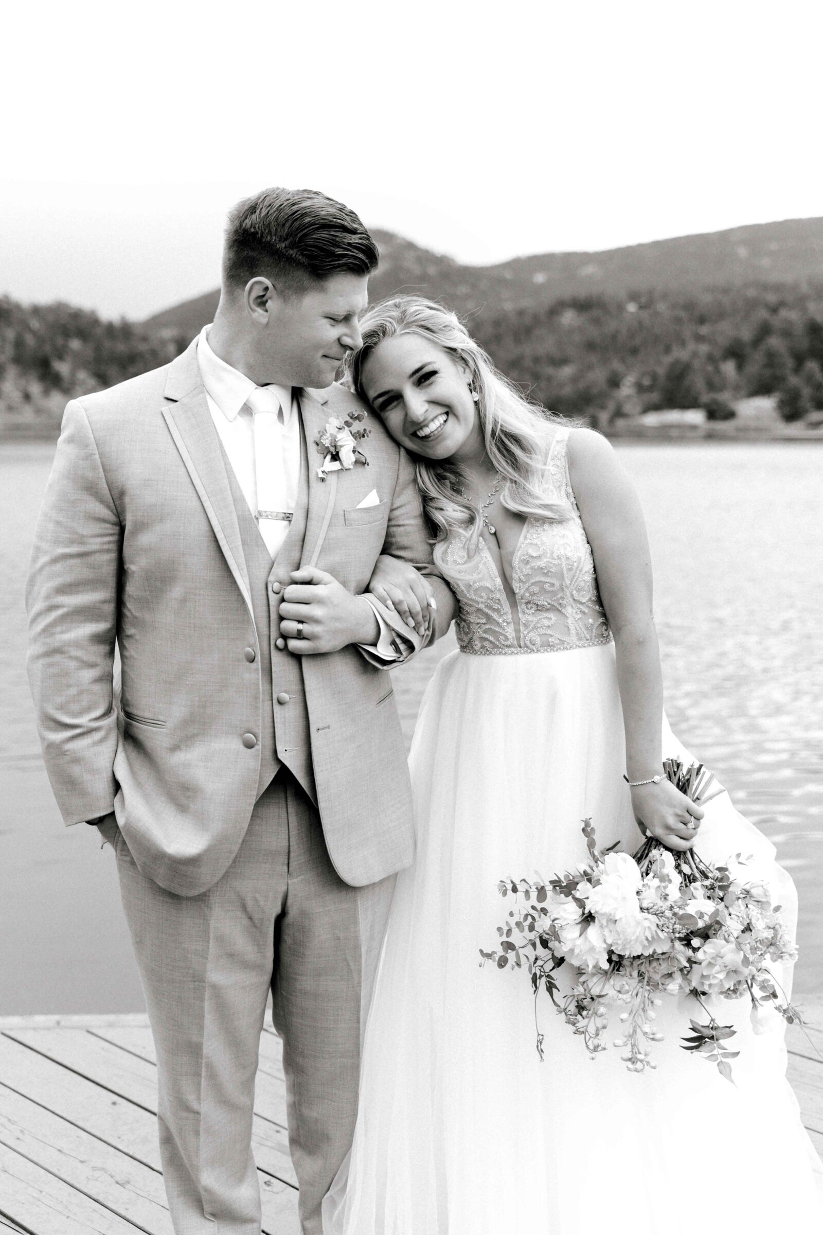 Sweet bride and groom at the lakeside