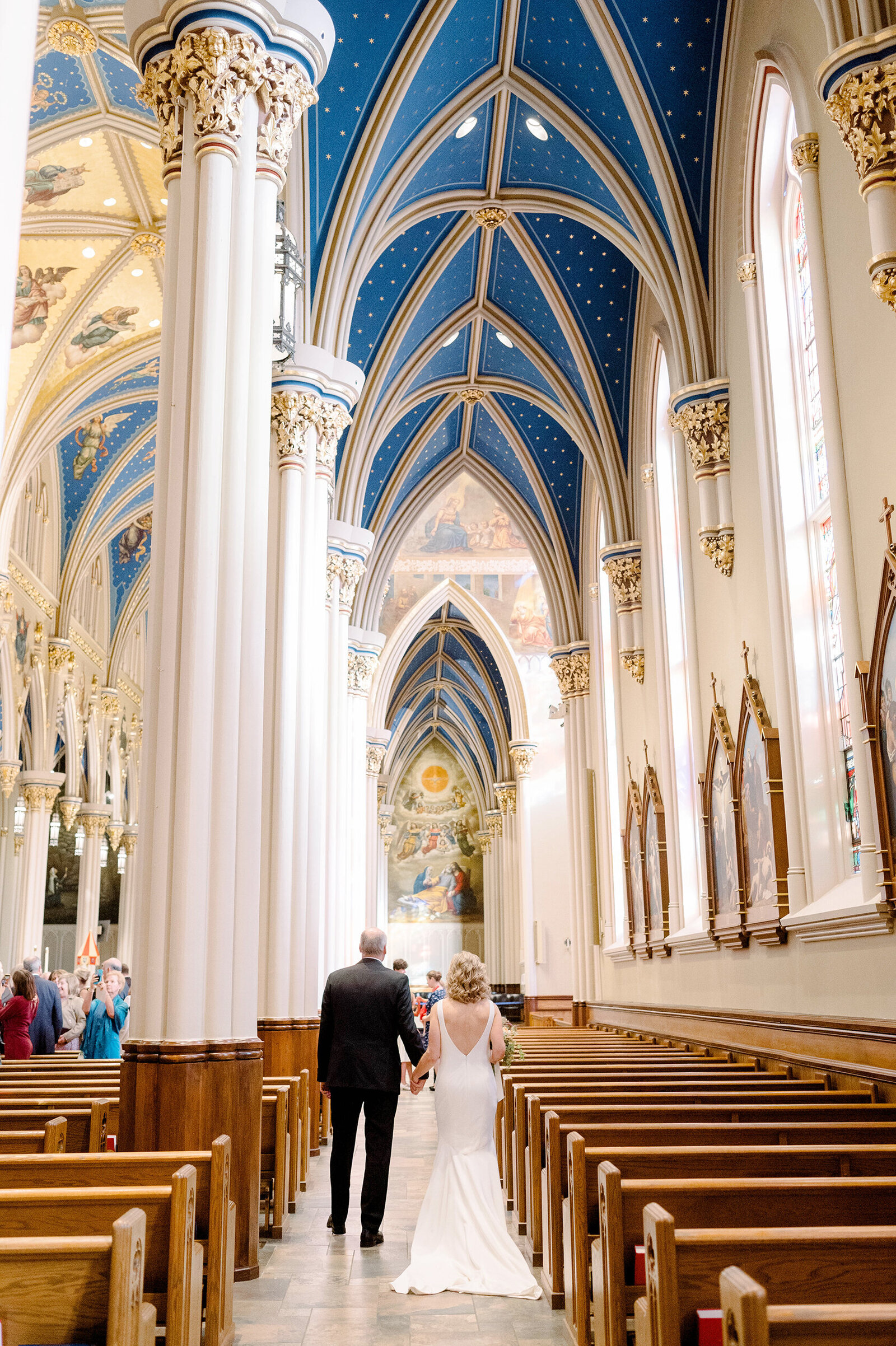 Bride and Groom walking away at the Basilica of the Sacred Heart