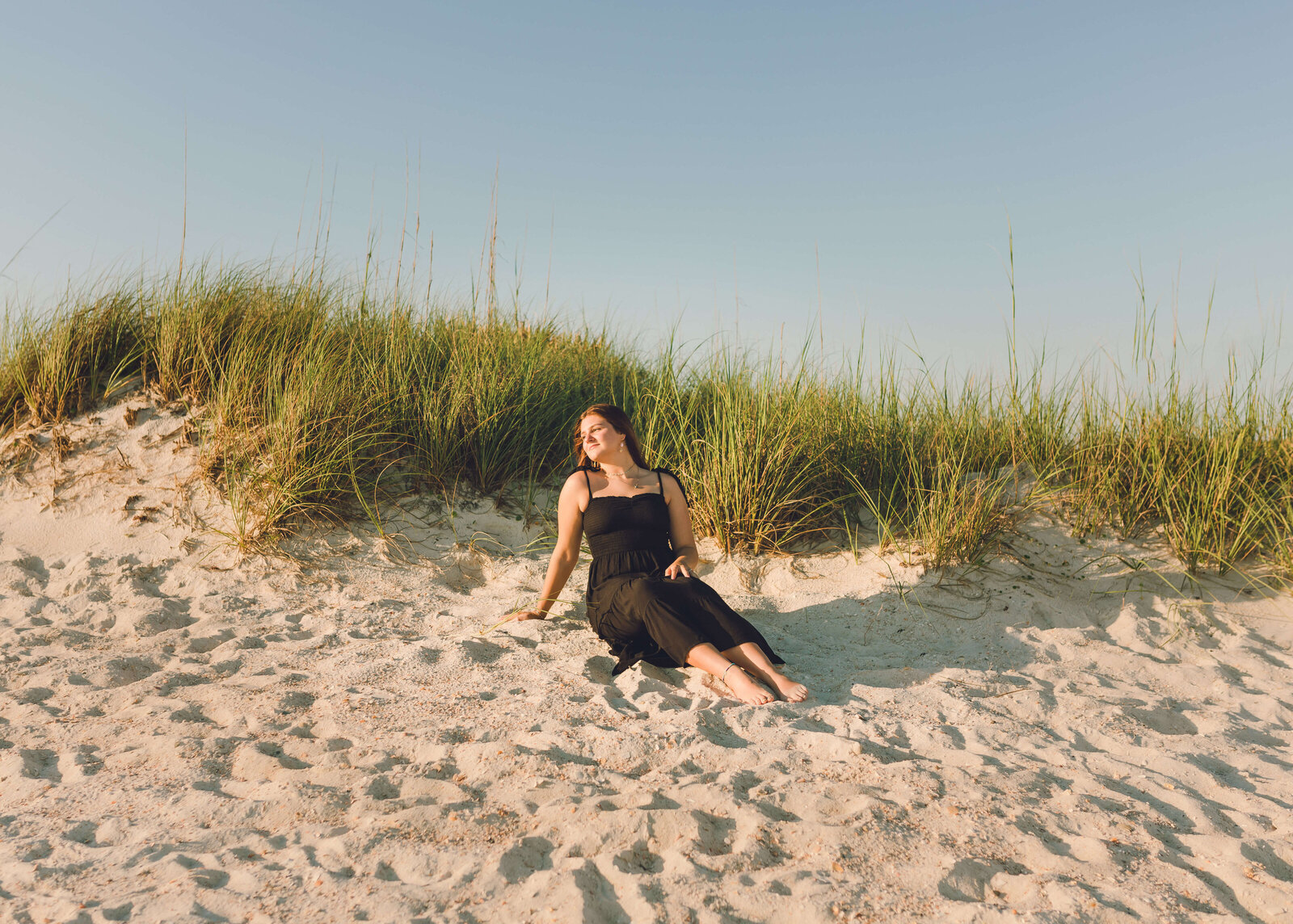 Nicole, high school senior poses in sand at st. andrews state park