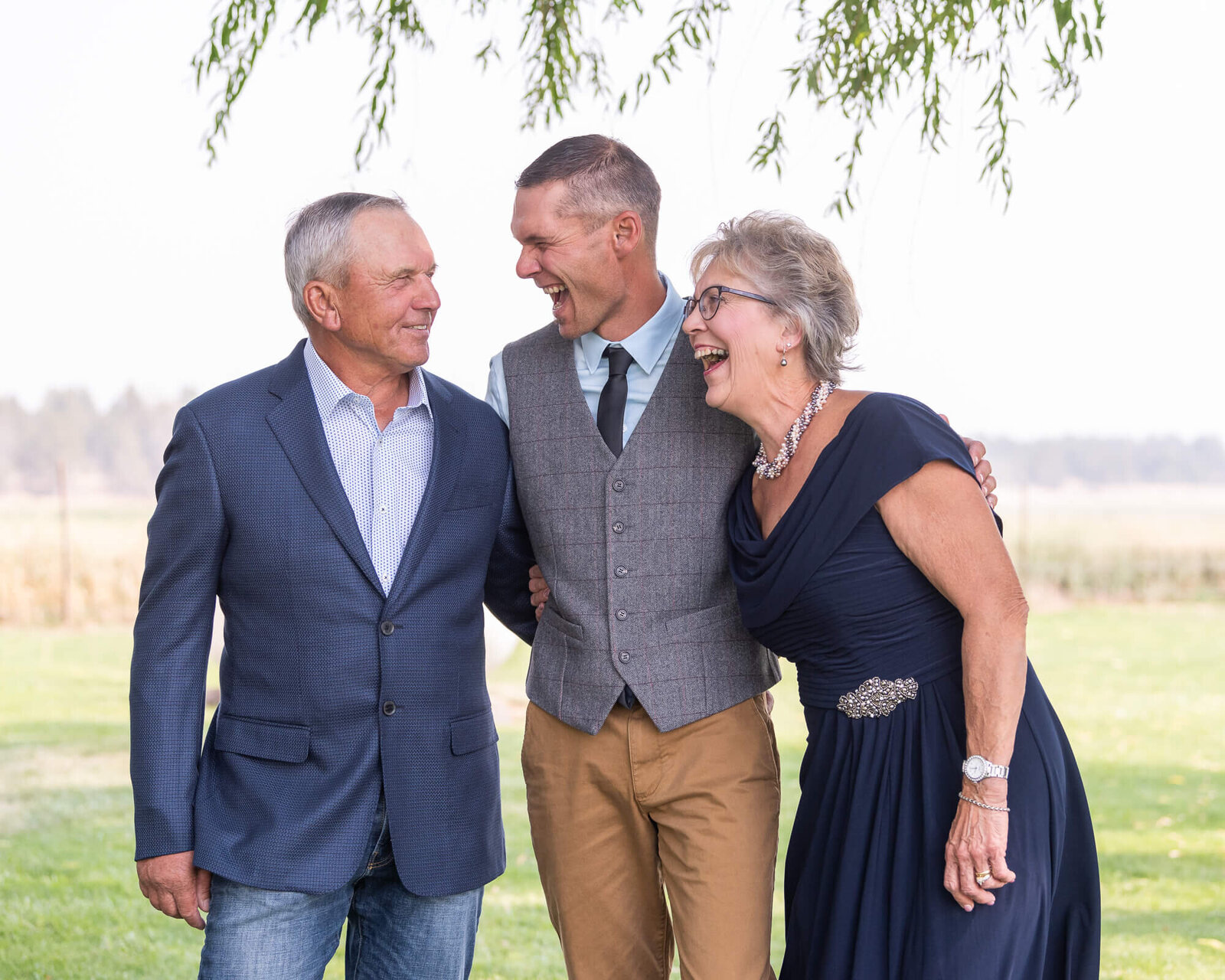 Picture of groom laughing with his parents