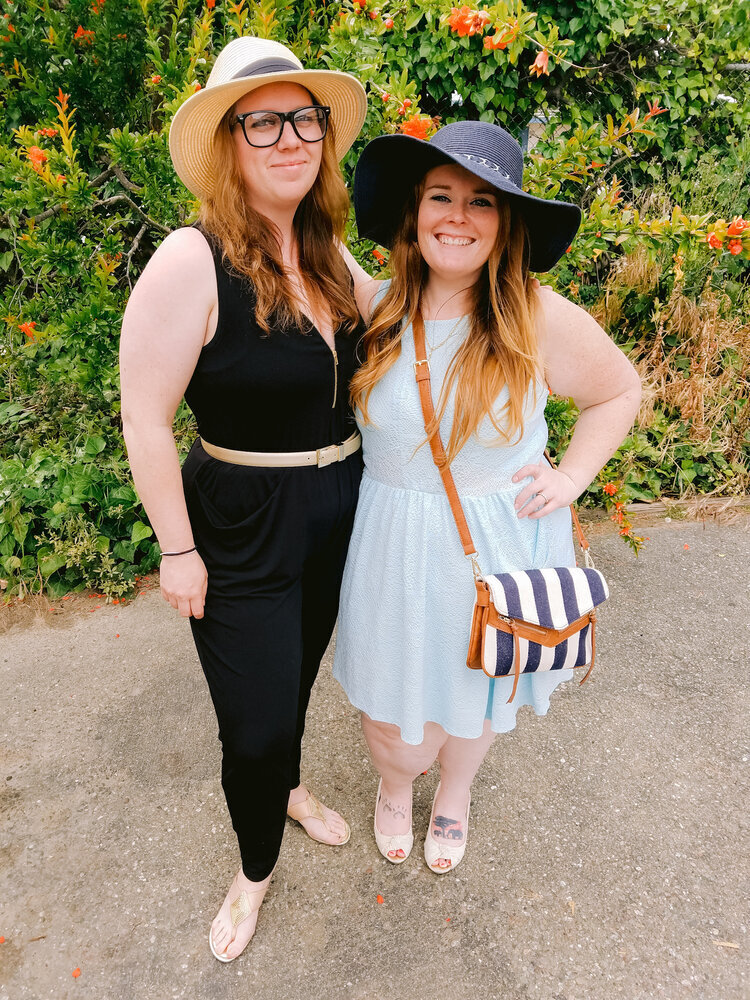 Two women wearing sunhats standing outside