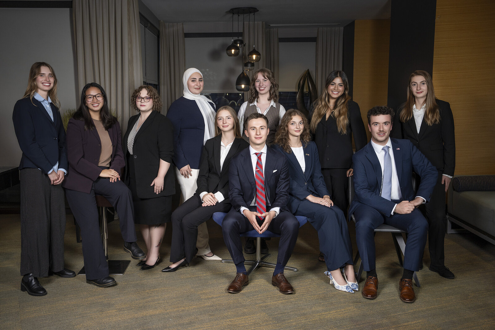 Couple poses for wedding photos in front of a flower display