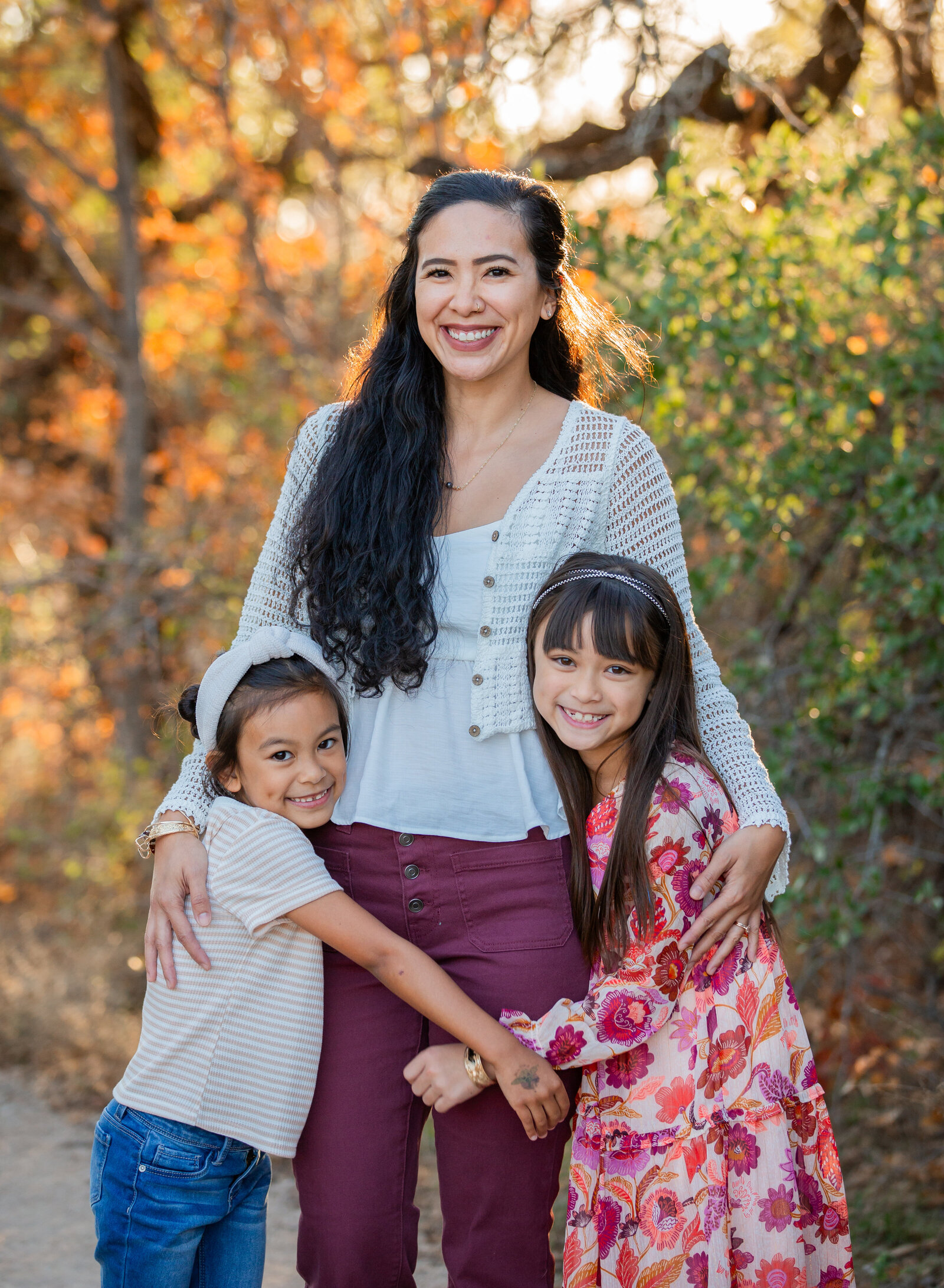 mom and two daughters hugging