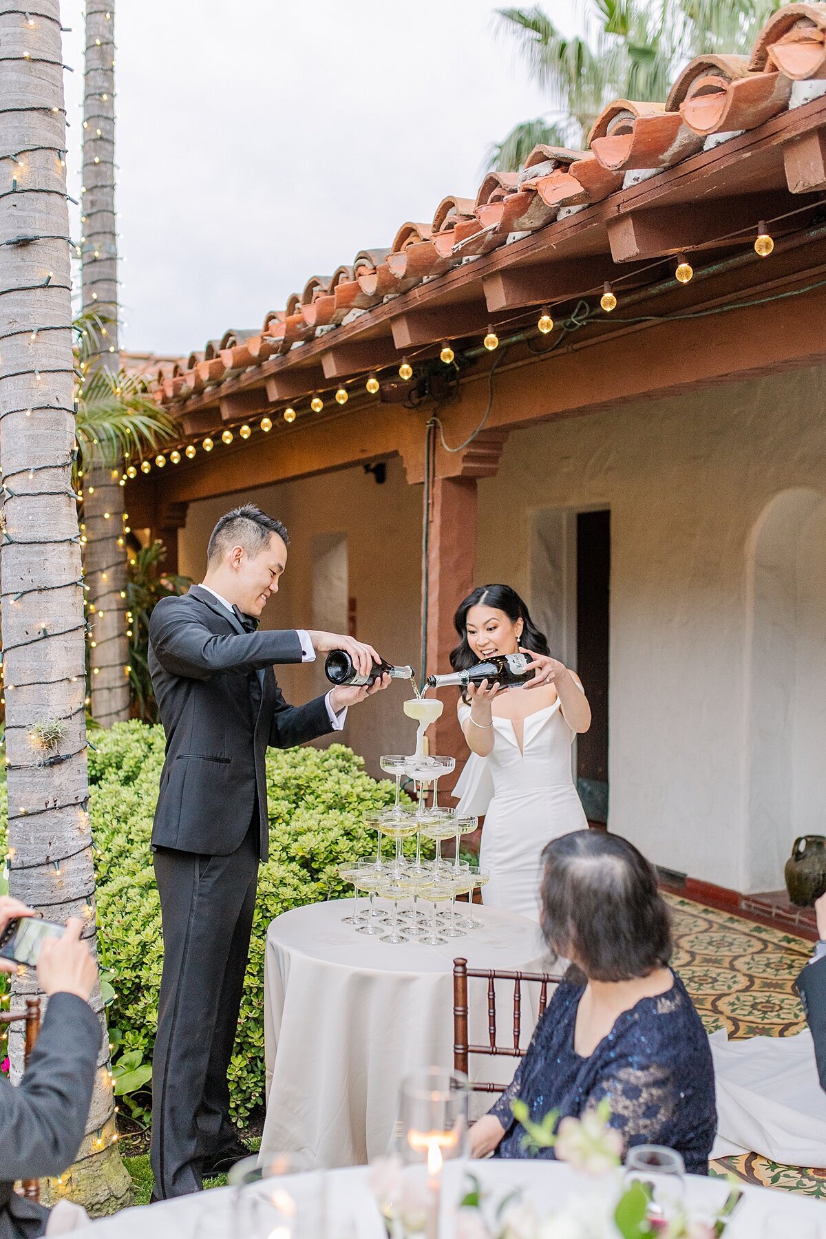 Bride and groom champagne tower pour at Casa Romantica in San Clemente.
