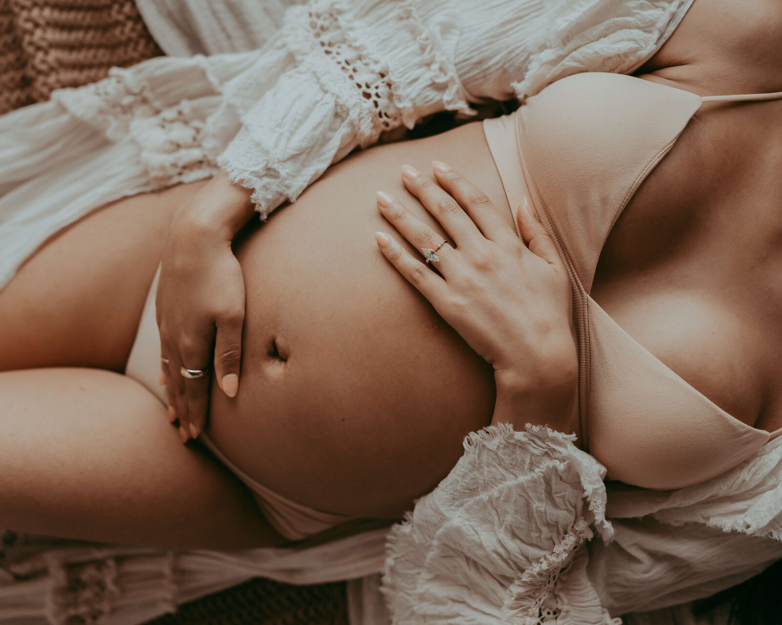 pregnant woman detailed image of hand on bare belly