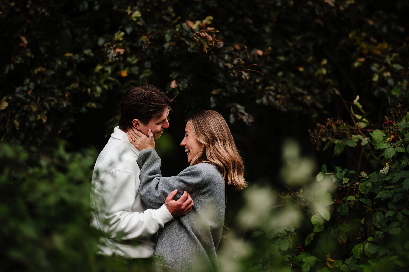 Her hands are on his face while they're laughing in a close embrace during their proposal photoshoot in London.