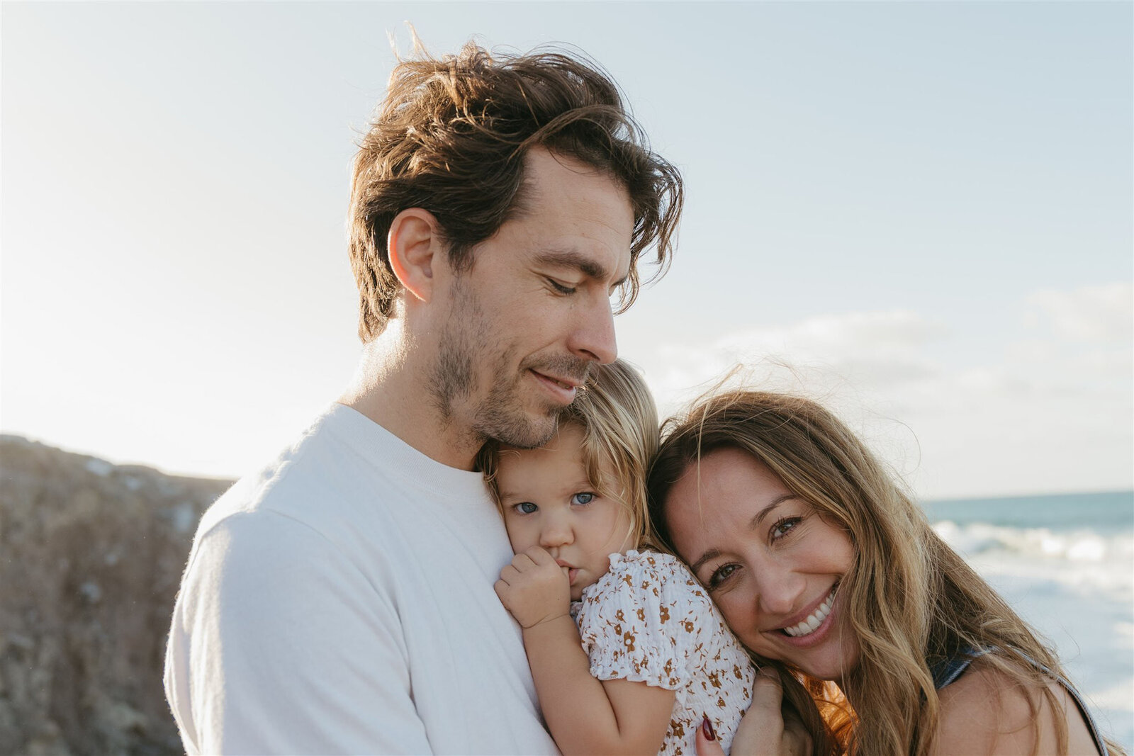 Parents and children embracing during a styled family photo shoot in Maui, golden hour editorial session.
