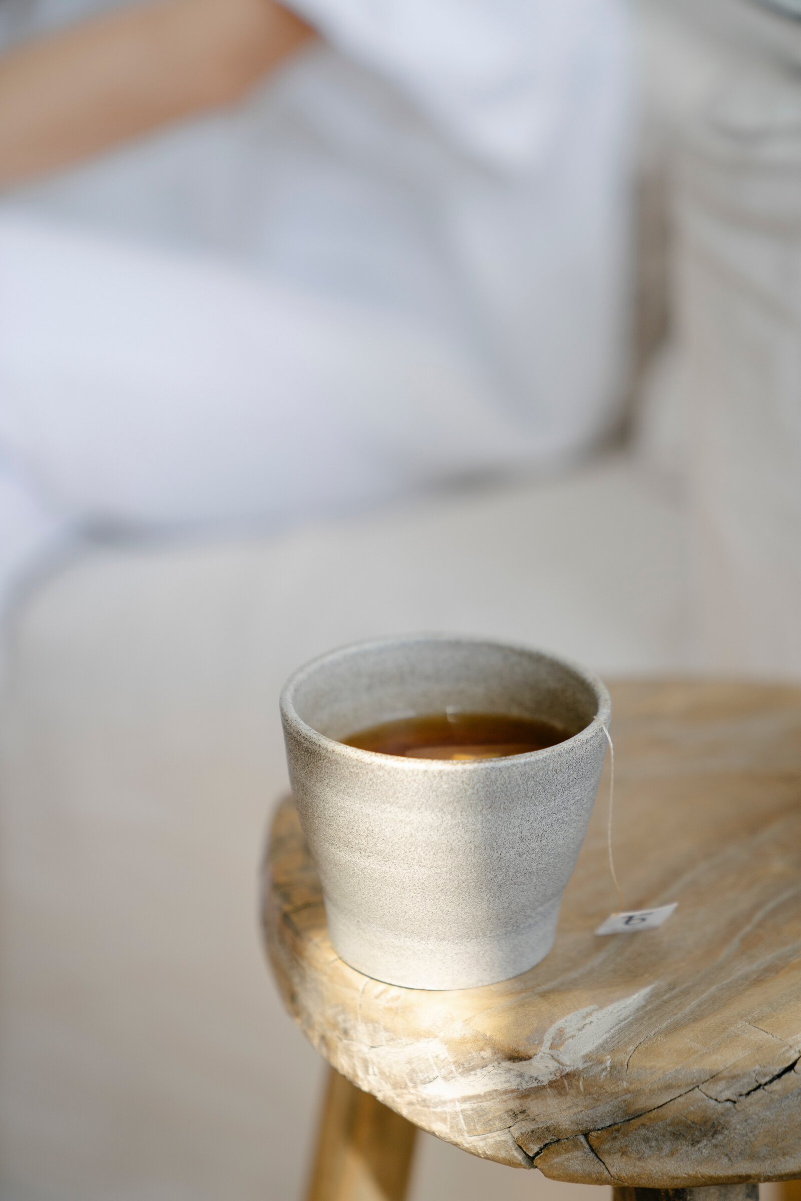 ceramic mug of tea on rustic wooden stool