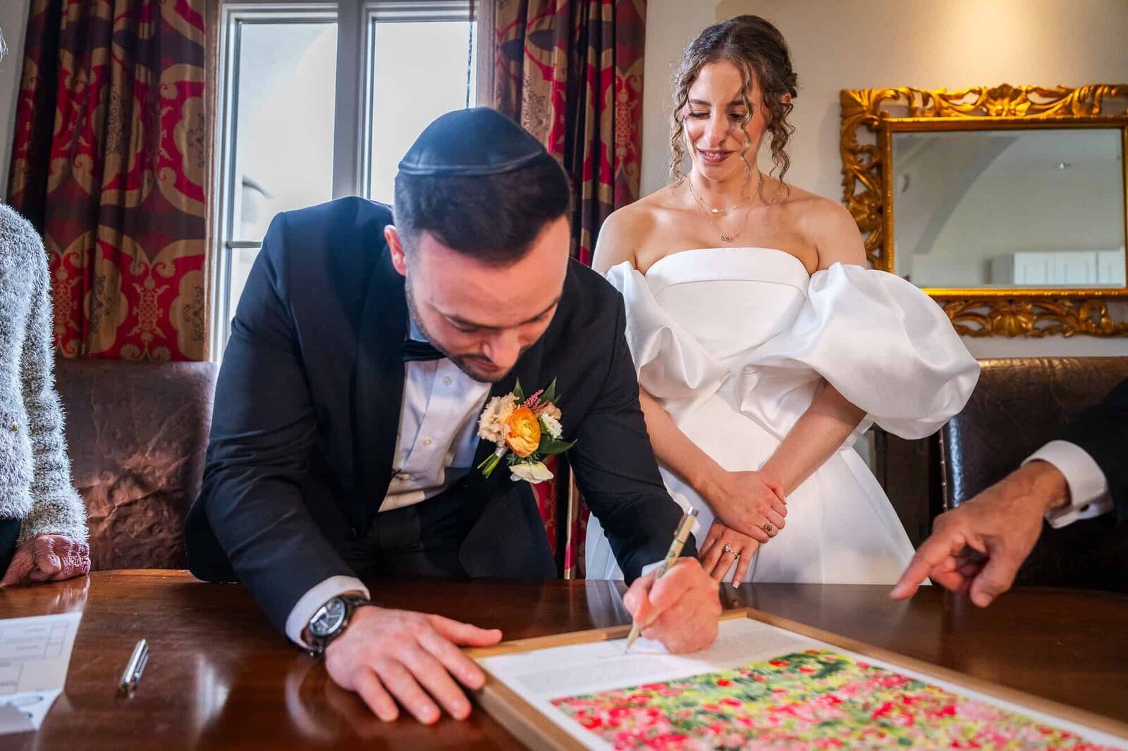 groom signing the Ketubah at jewish wedding - Casa Monica Wedding venue in St Augustine