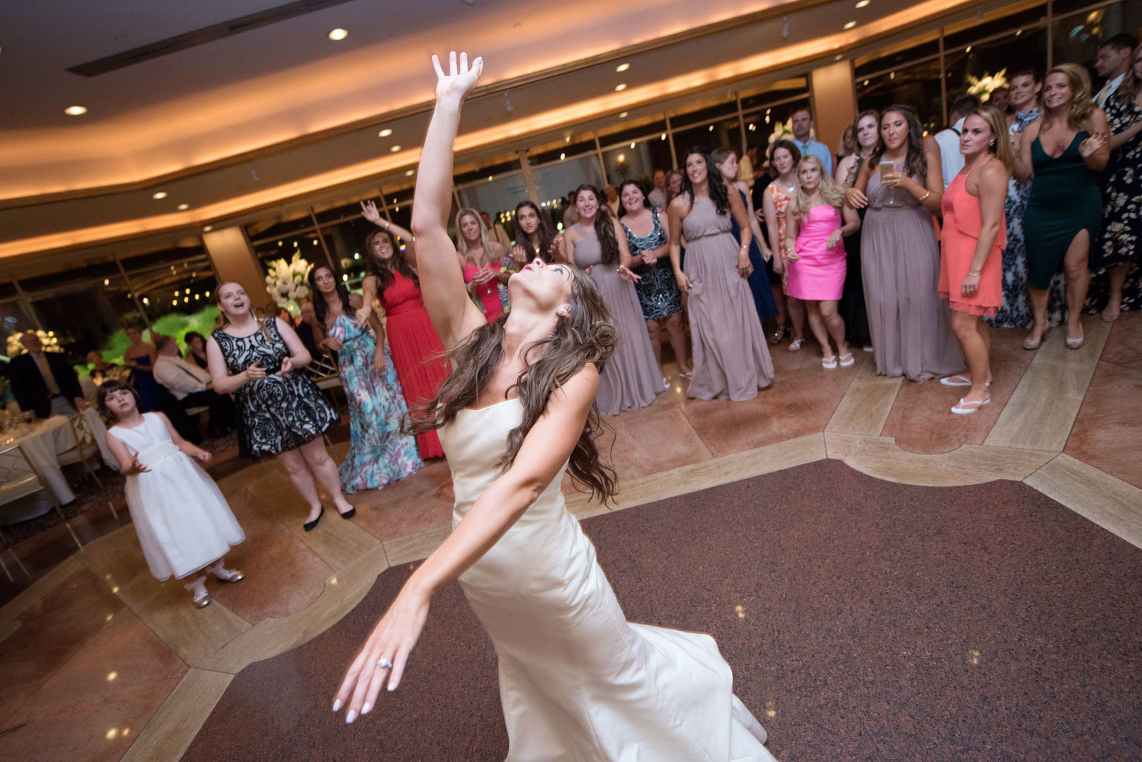 bride throwing her bouquet at Glen Island Harbor Club