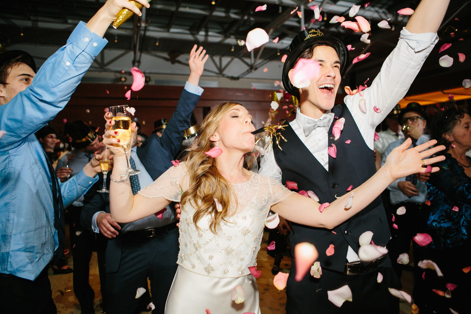Bride and groom photographed having the time of their life at their wedding reception.