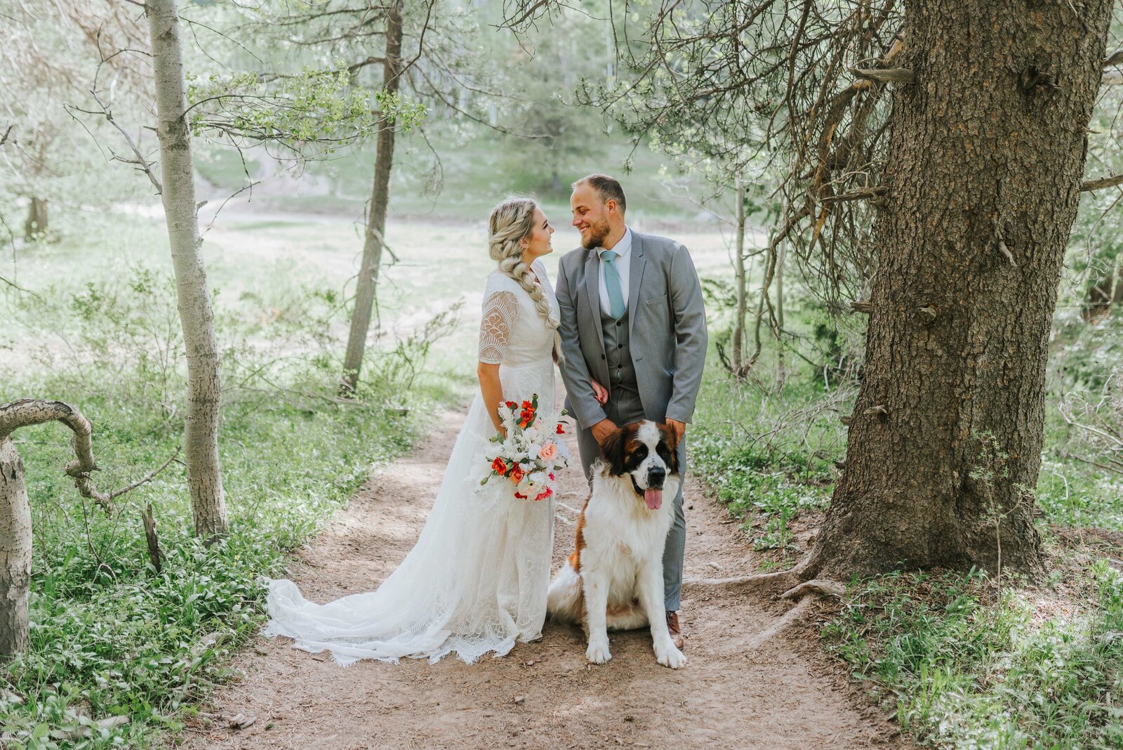 Big Sur wedding photographer captures couple in forest with dog during bridal portraits