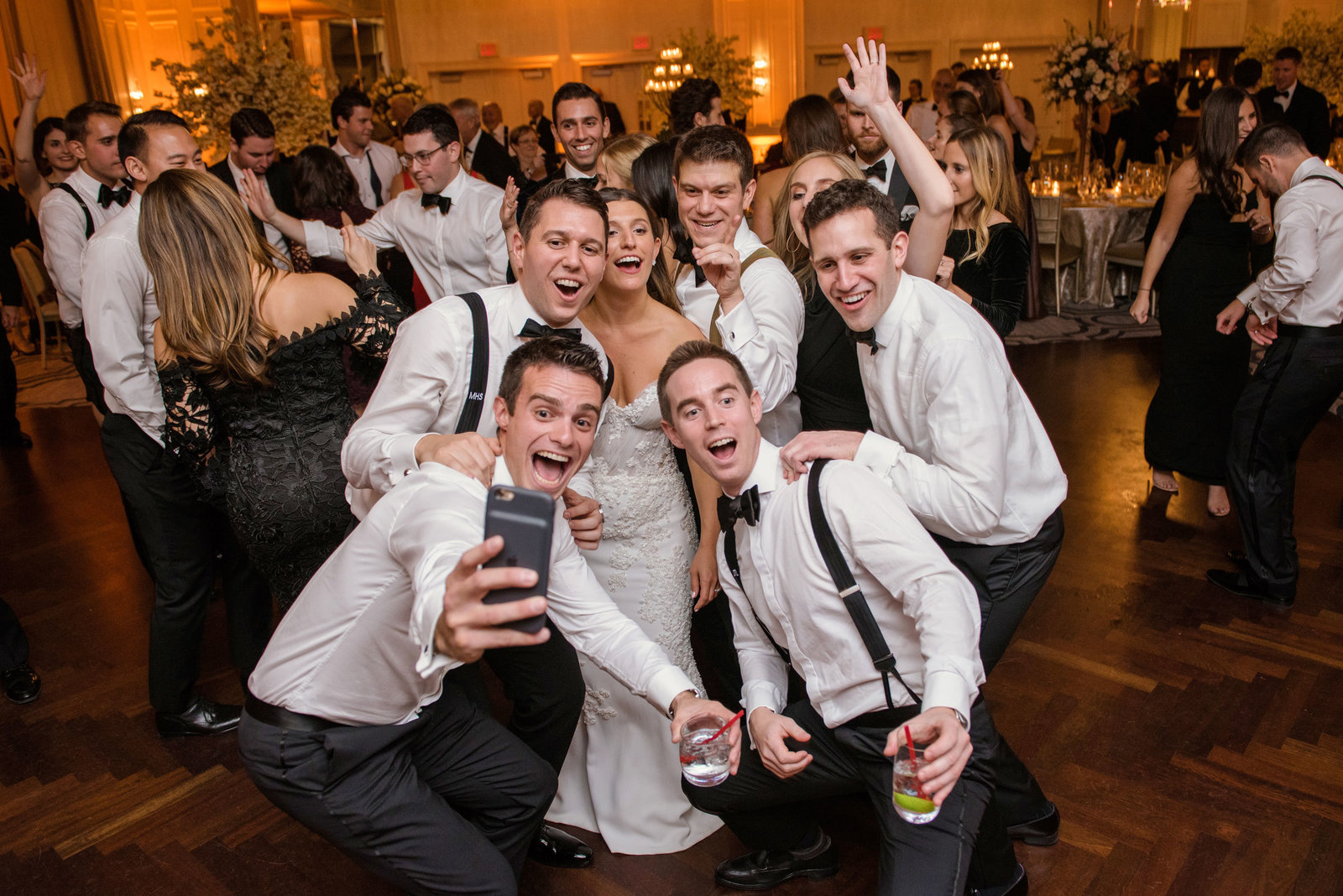 groomsmen taking a selfie with the newlyweds at Glen Head Country Club