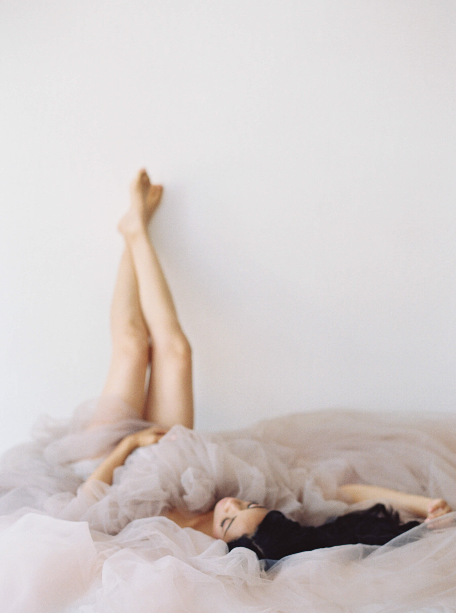 Woman with feet up posing for maternity photoshoot in San Francisco