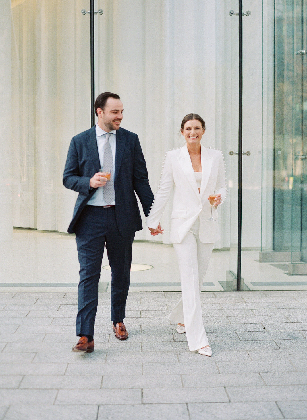 Bride and Groom Holding hands walking at Rehearsal Dinner