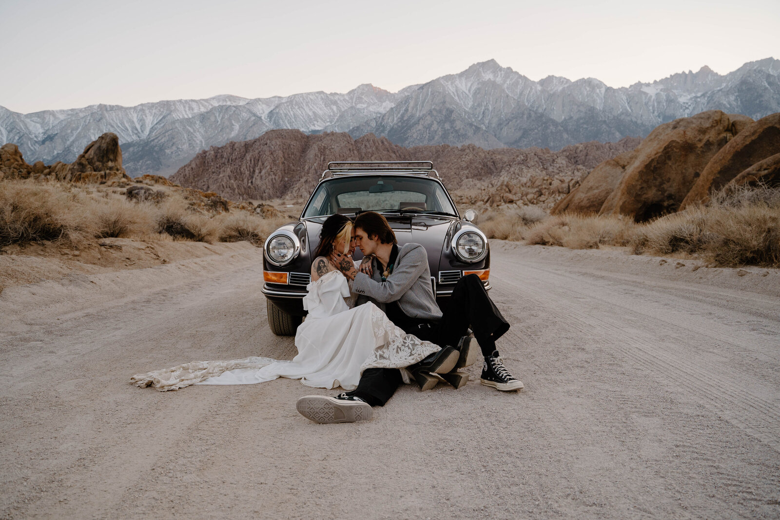 Edgy sunset elopement photography in Lone Pine, California featuring a vintage Porsche car