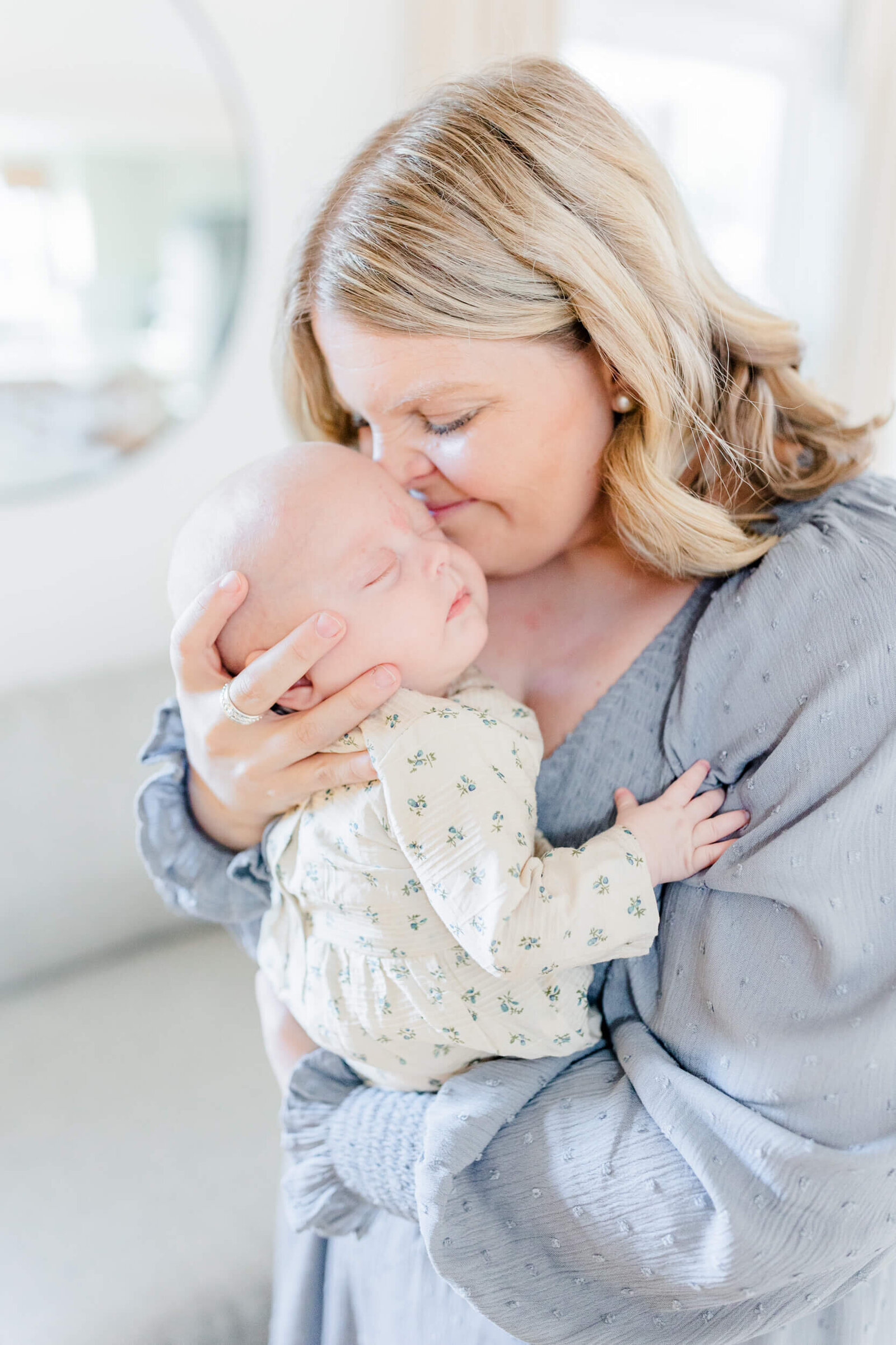 Mom nuzzles her newborn with her nose