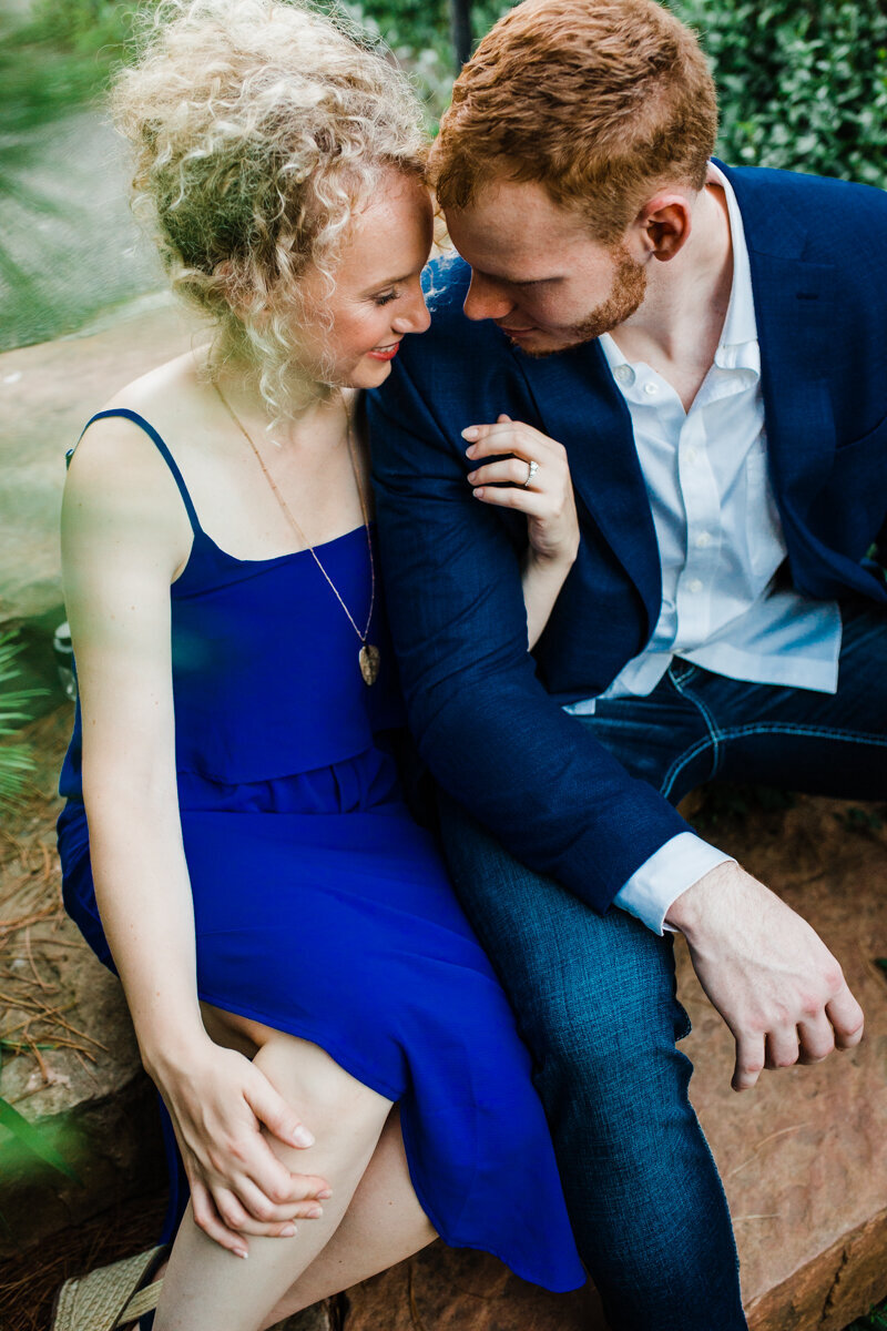 couple sitting and snuggling at the Chicago Botanic Garden Engagement session by Chicago wedding photographer Bozena Voytko