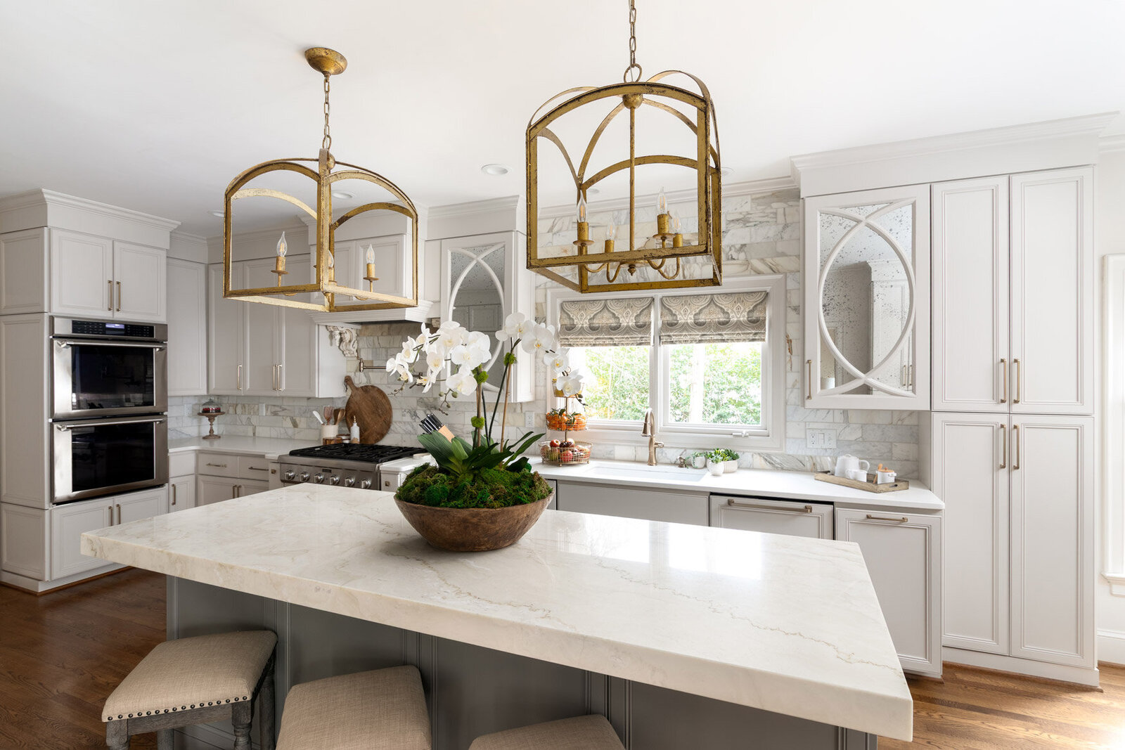 Luxurious neutral kitchen with custom cabinetry designed by Zimmer Interiors.
