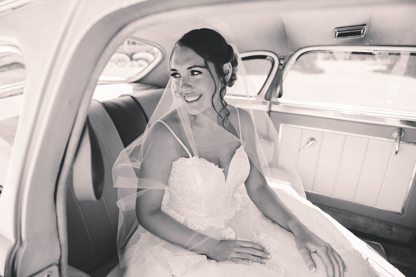 Bride gazes out of the window of a classic car on her wedding day in Asheville, NC.