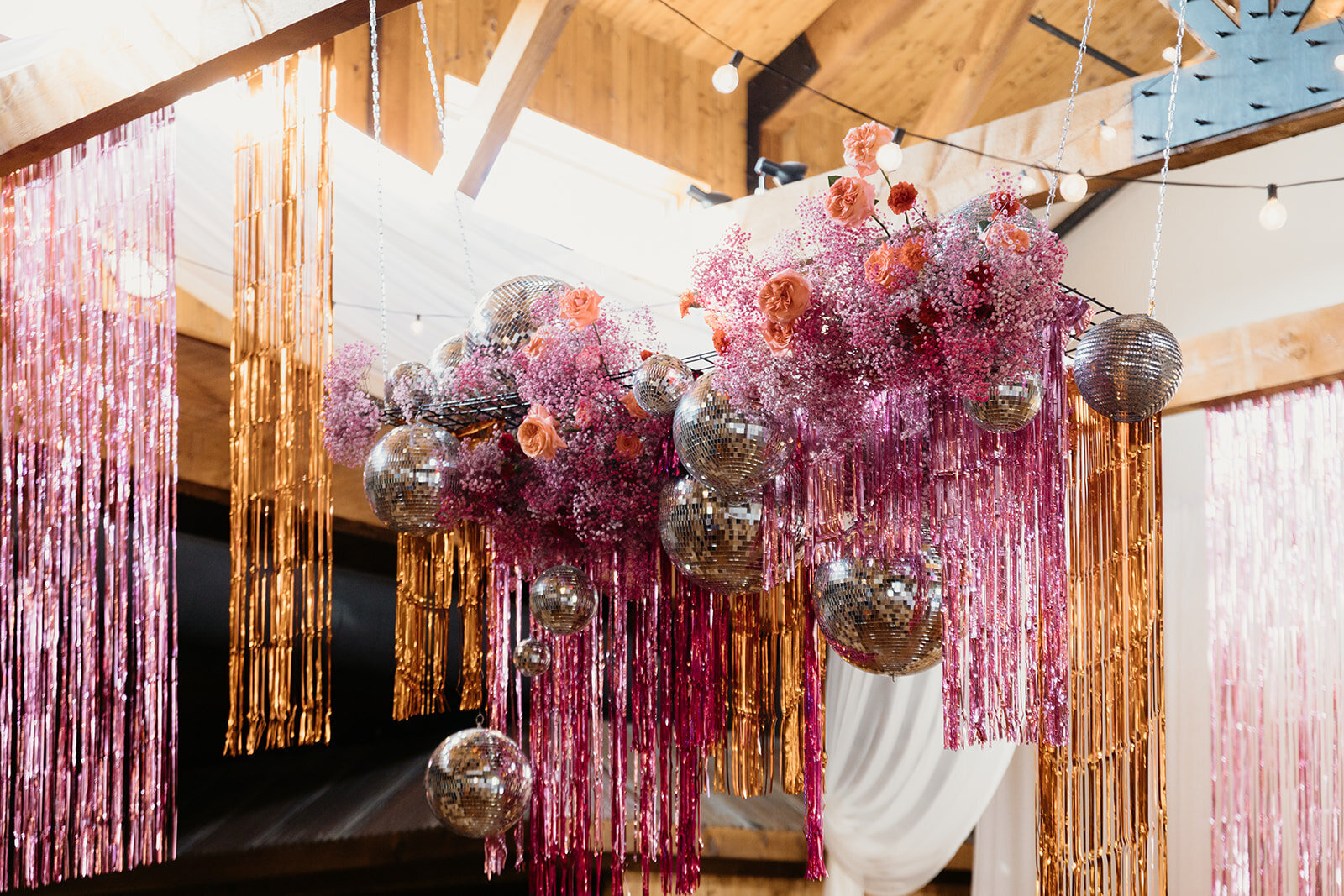 Dramatic hanging florals over a reception table. Designed by The Floral Eclectic to create a sculptural, immersive atmosphere.