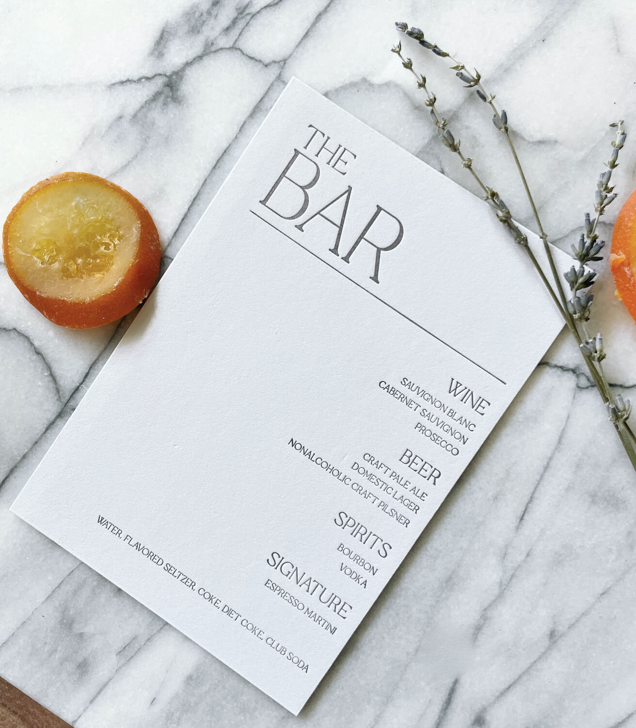 Minimalist bar menu with dried citrus and lavender.