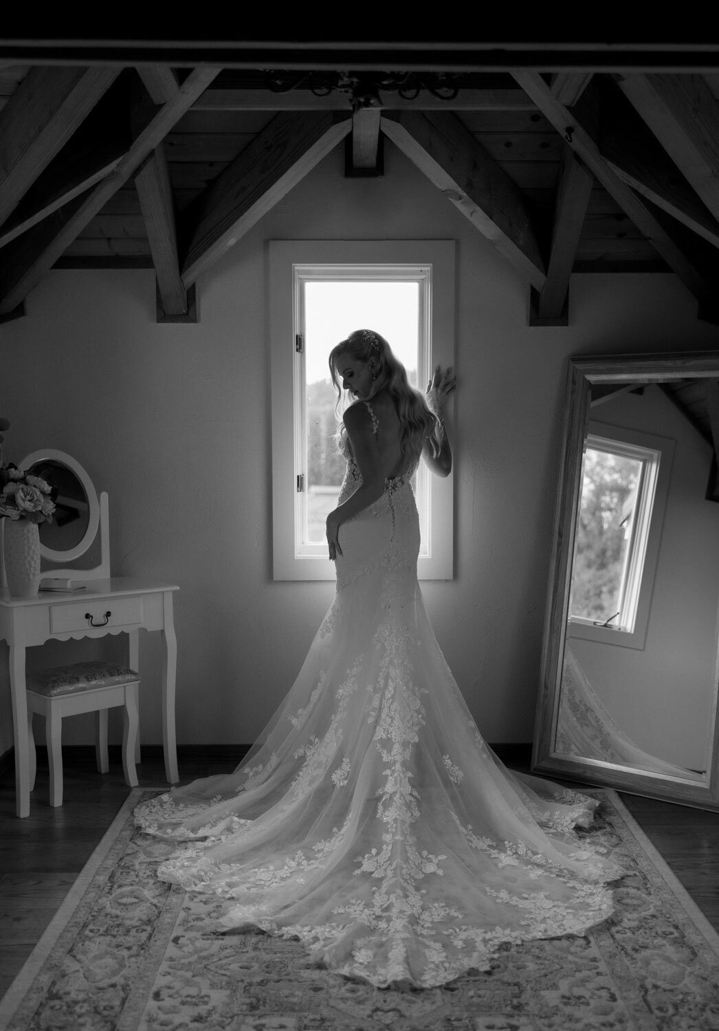 Bride in a lace gown near a window