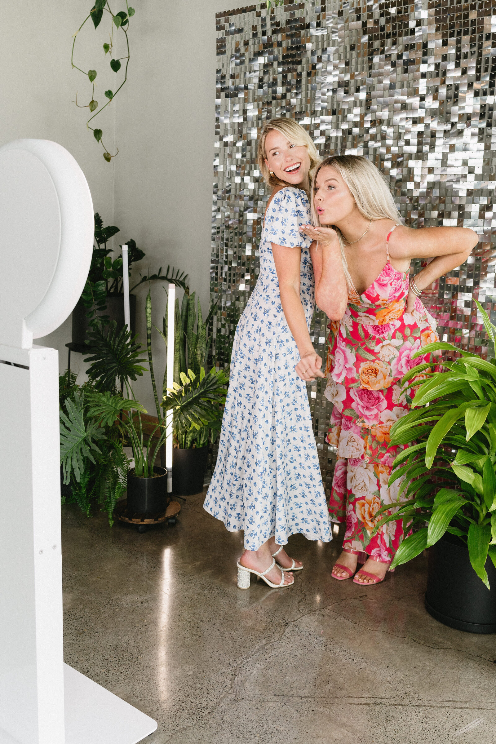 Women taking a picture with the photo booth.