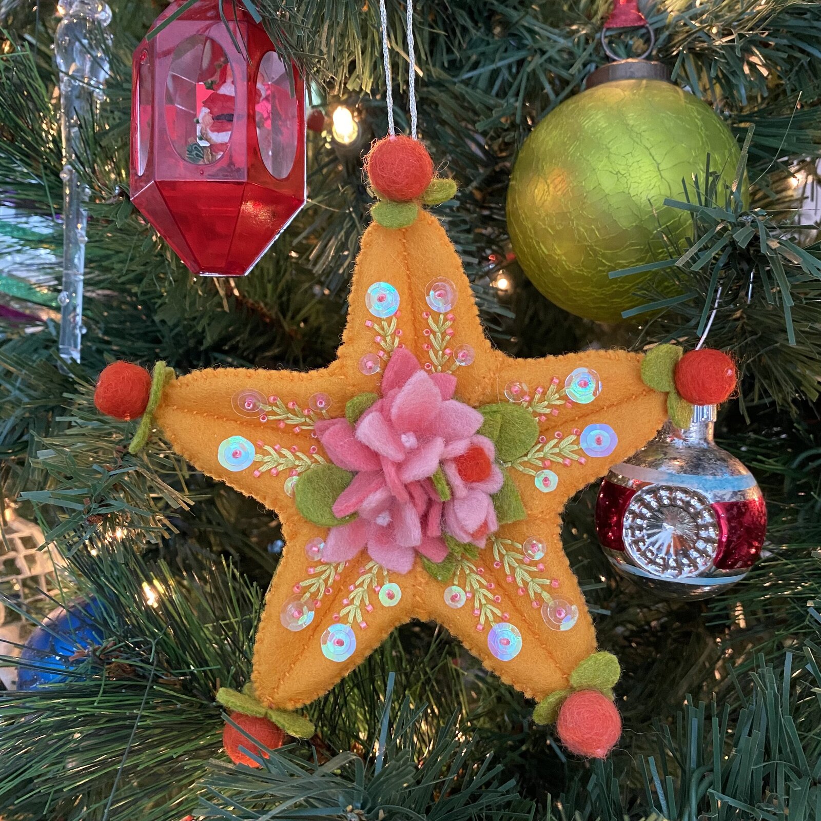 Star ornament made out of felt and sequins.