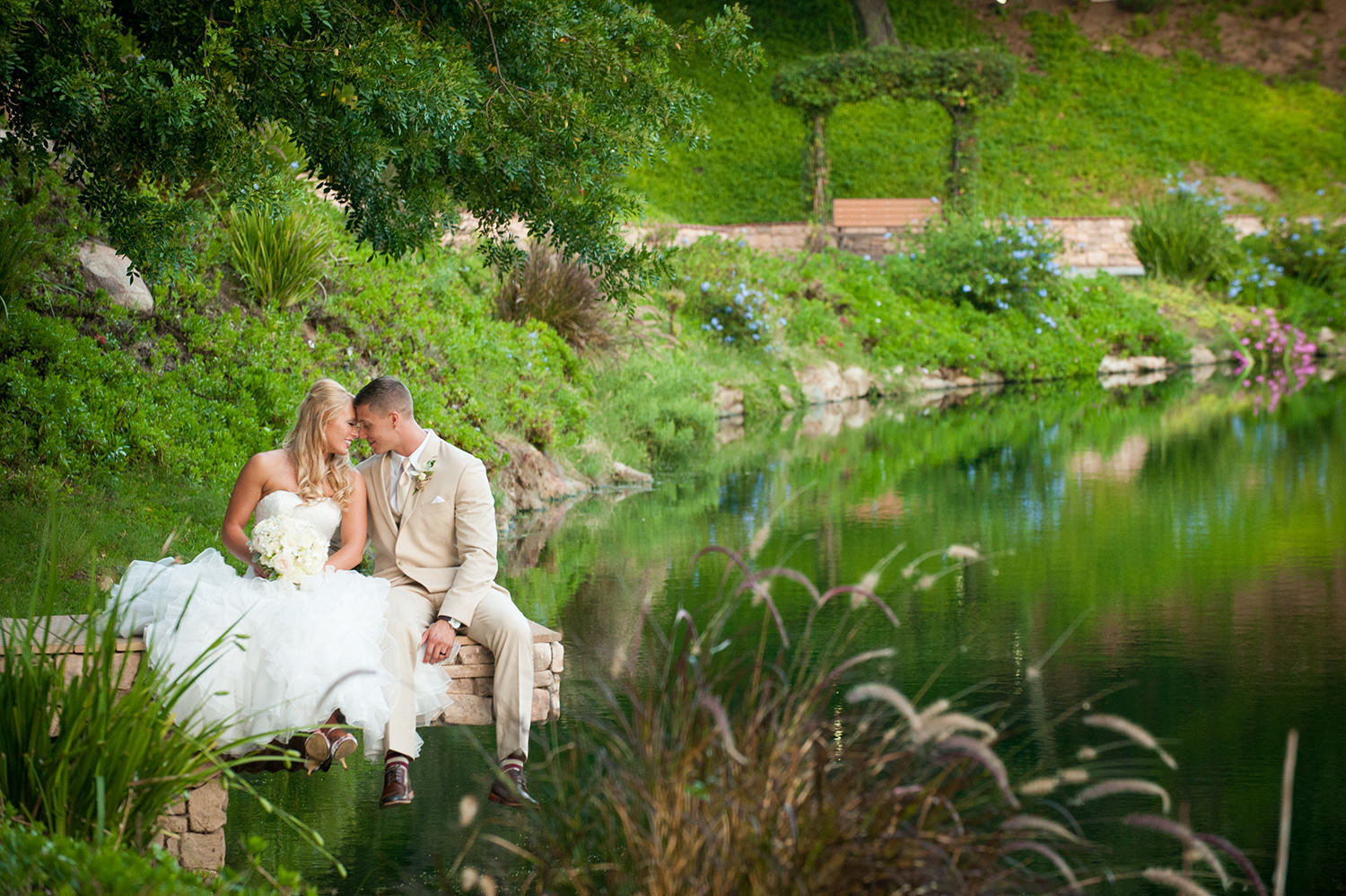 bride and groom by lake at los willows