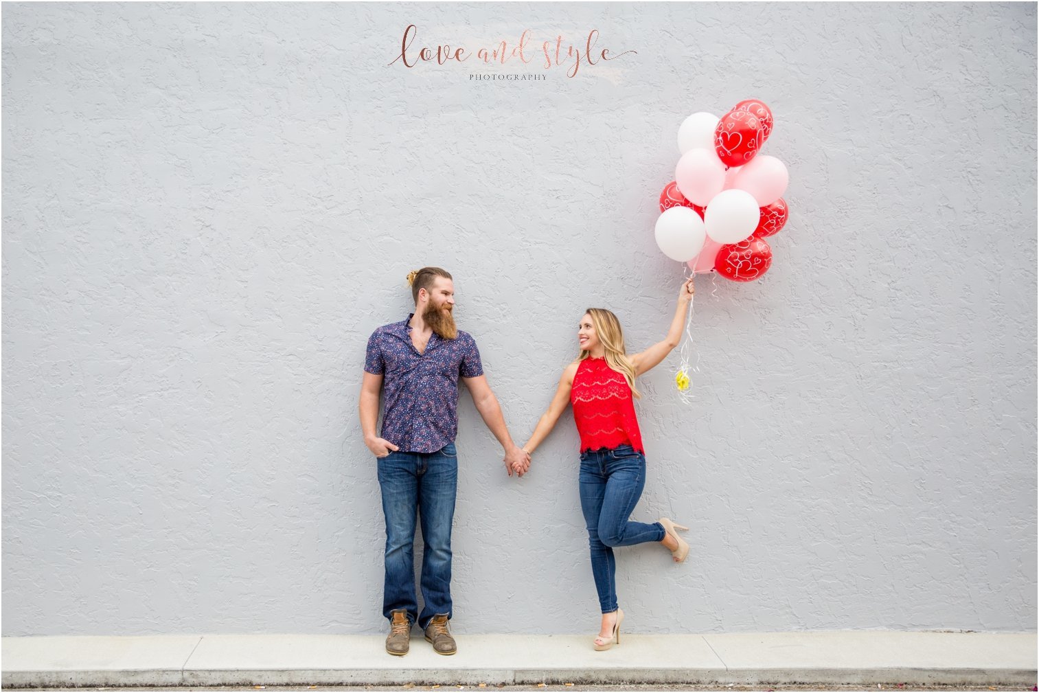 Sarasota Engagement Photography with red and pink balloons downtown