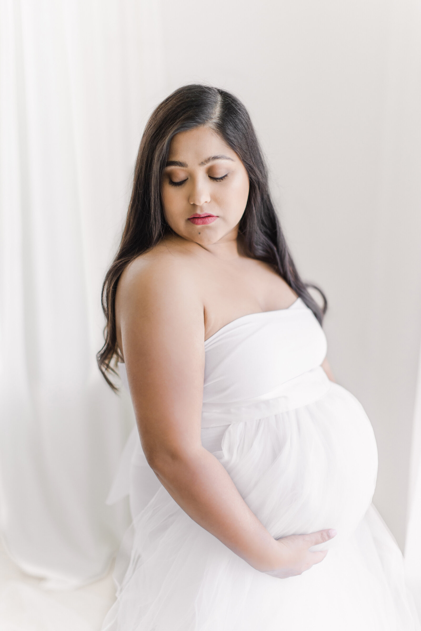 Romantic tulle maternity session in Bentonville AR Studio.