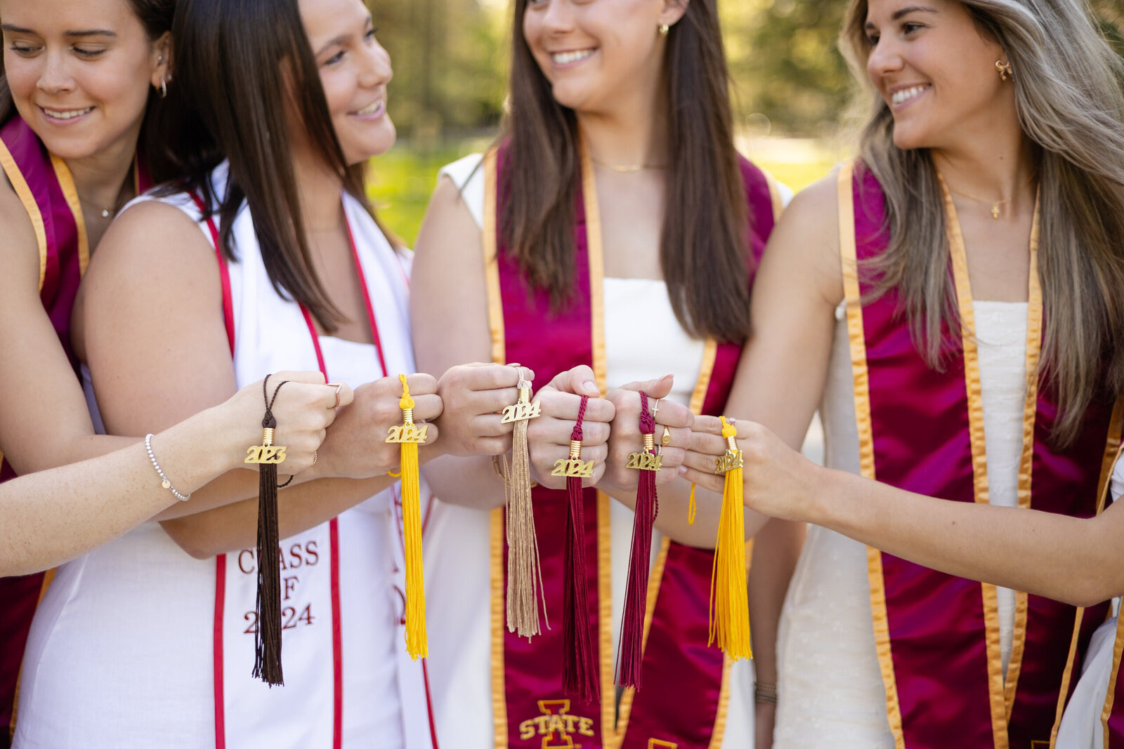 group of college graduates pose with graduate tassels