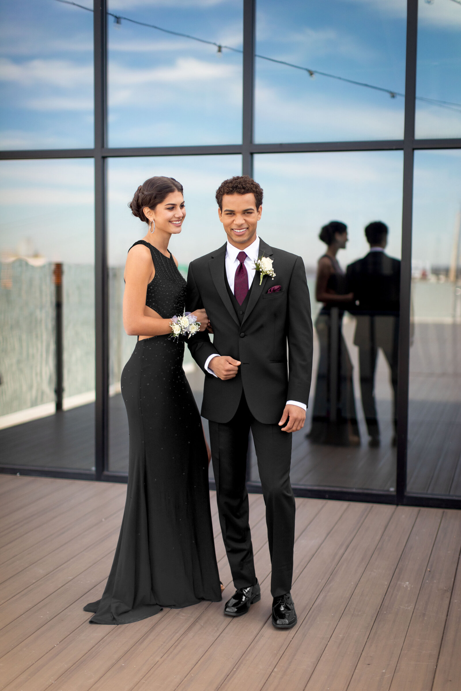 Couple dressed in black formal attire posing together