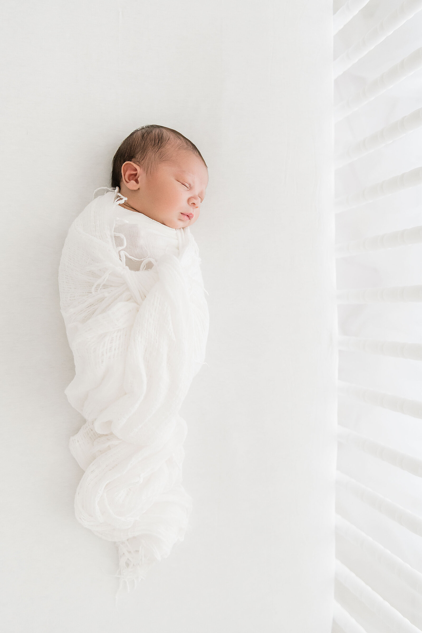 newborn in a crib with Destin newborn photographer