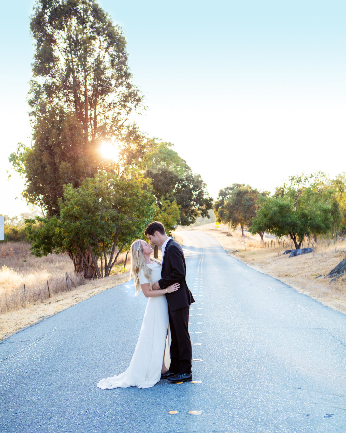 Northern California engagement session, bride and groom stands in street with golden hour lighting