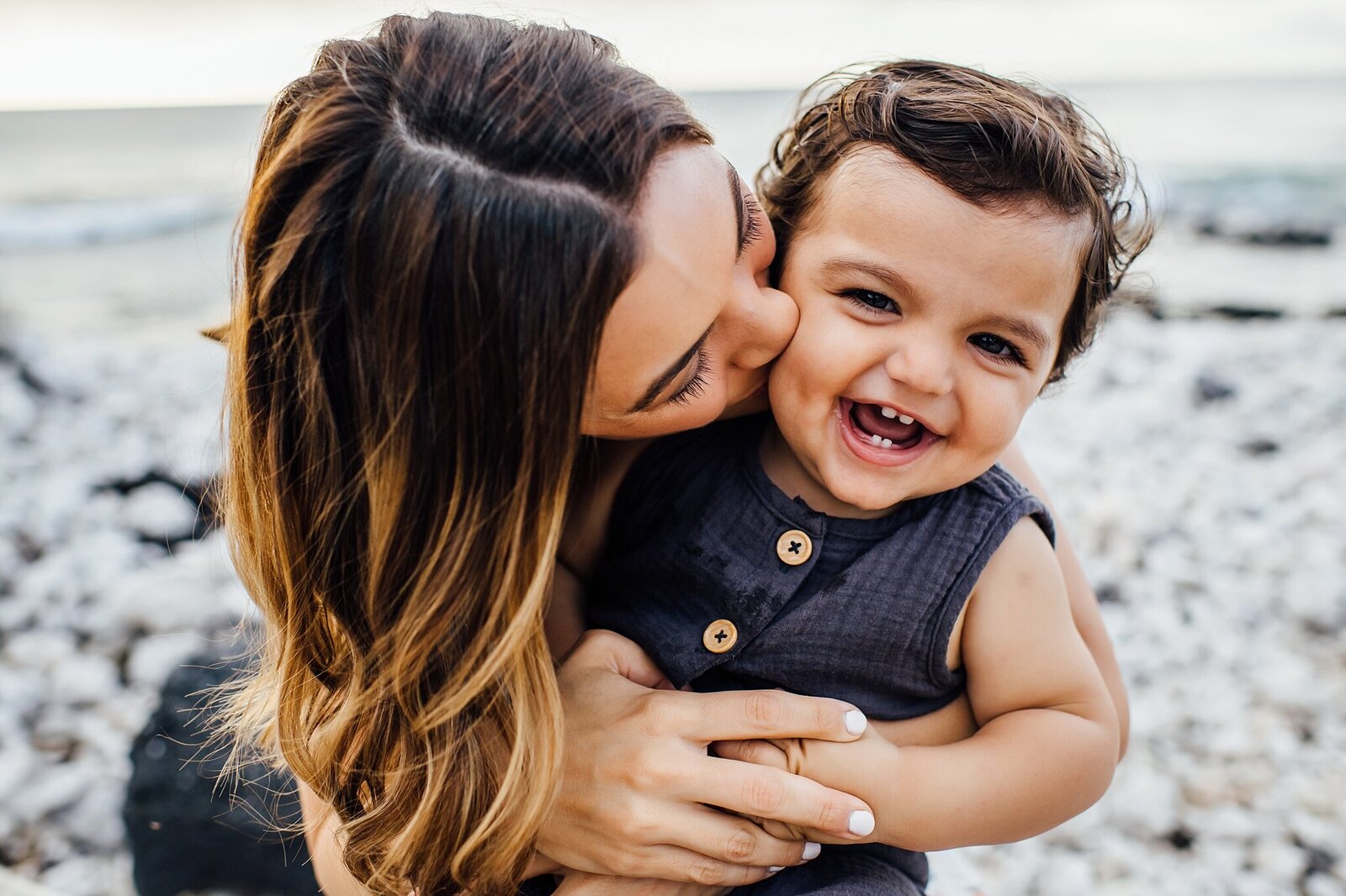 mama kissing beautiful baby boy