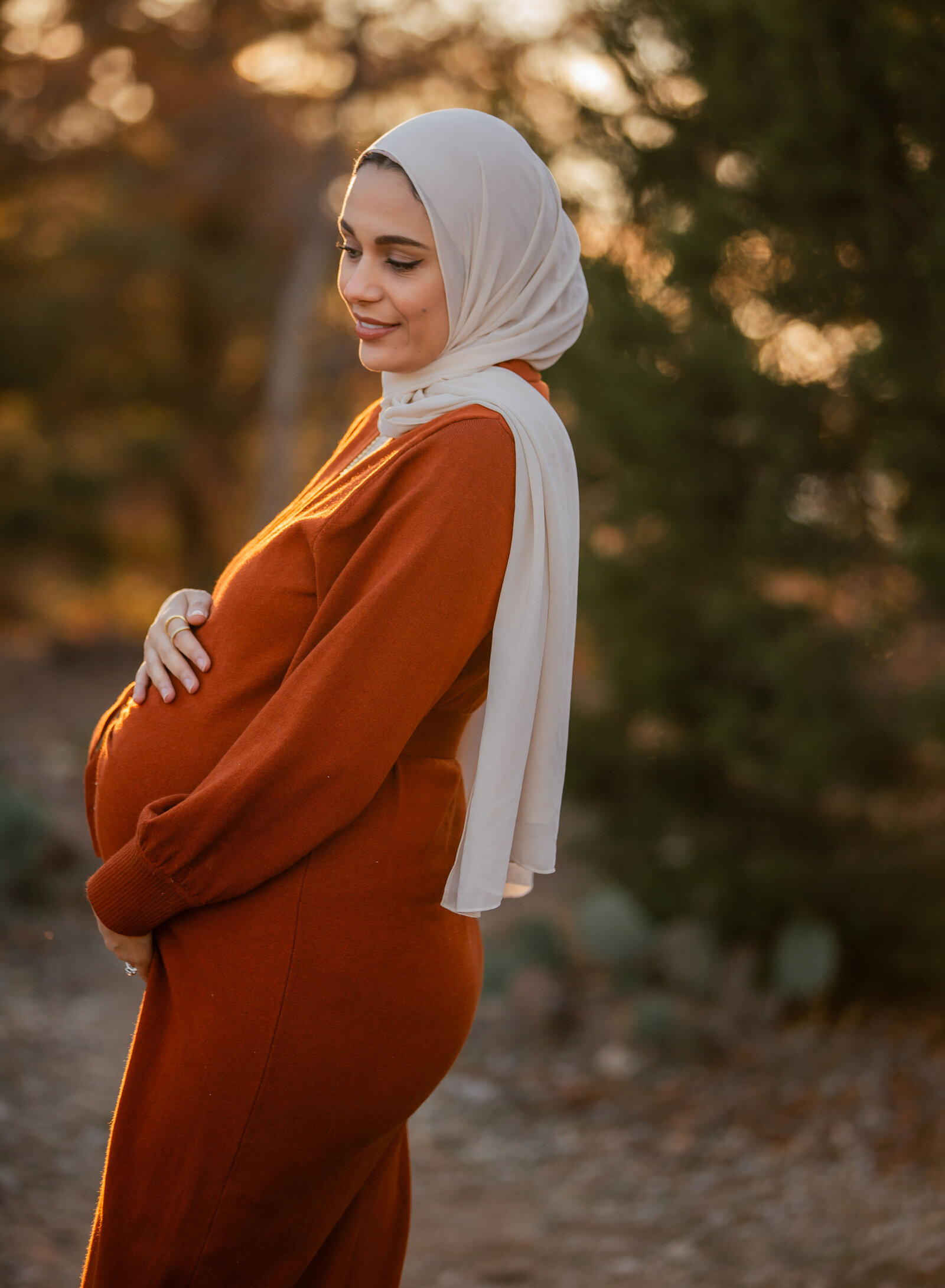pregnant mom in golden light with hijab