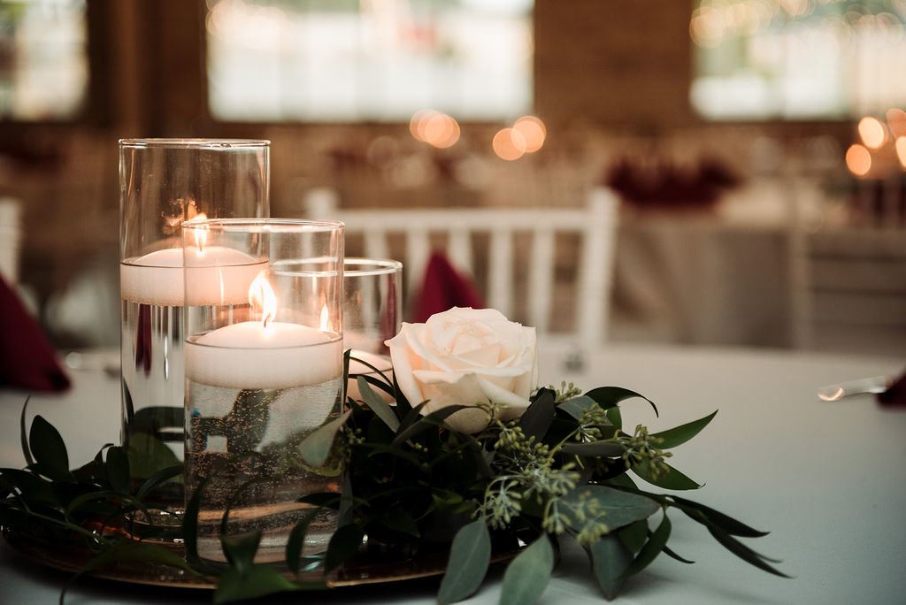 Wedding centerpiece with floating candles and roses