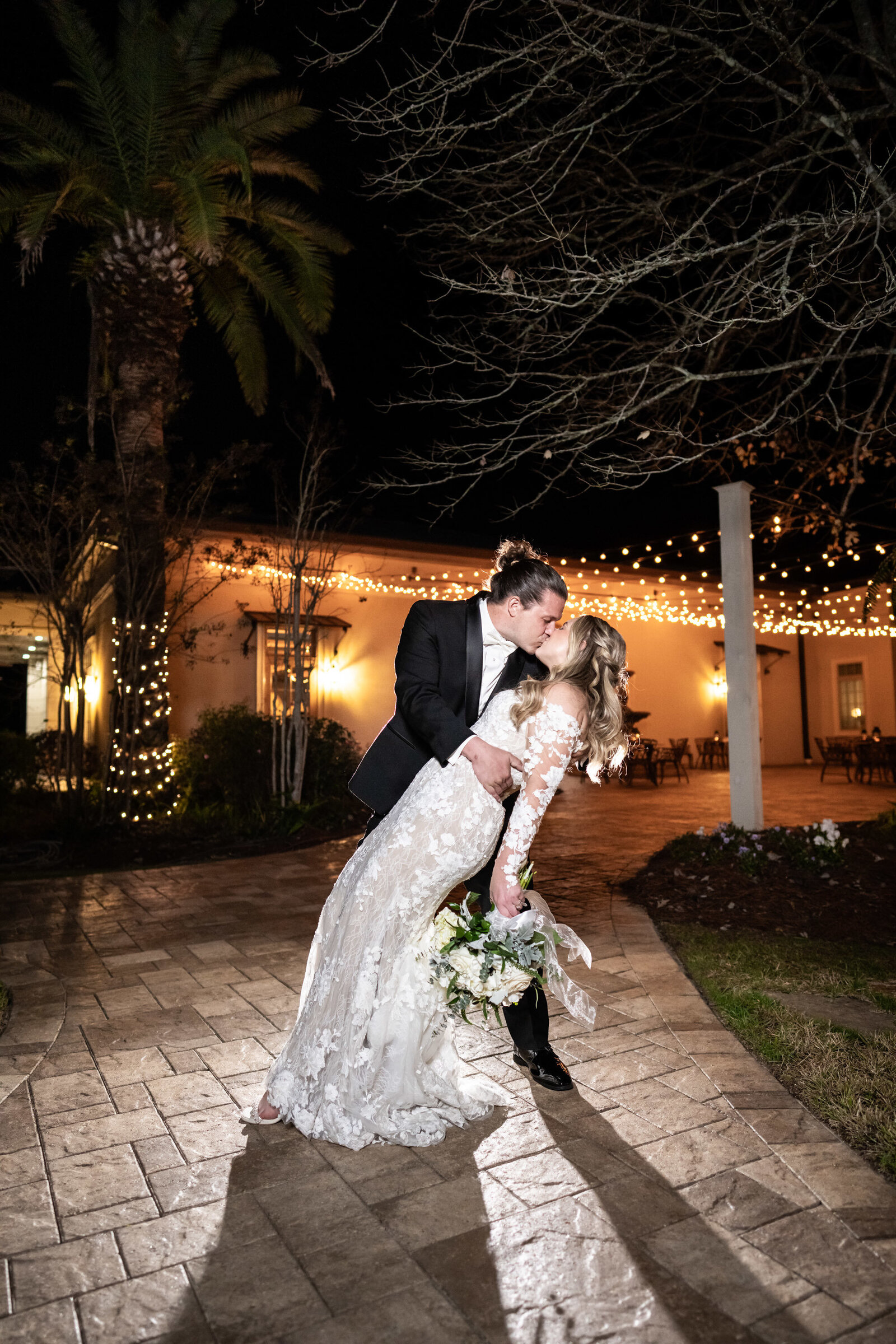 Bride and groom dip and kiss at Greystone Mandeville wedding