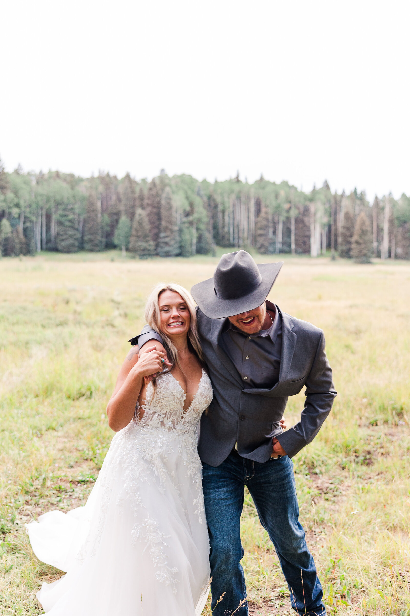 Great motion capture as bride and groom hold each other during their sunset portraits at their Arrow Head Lodge Wedding -