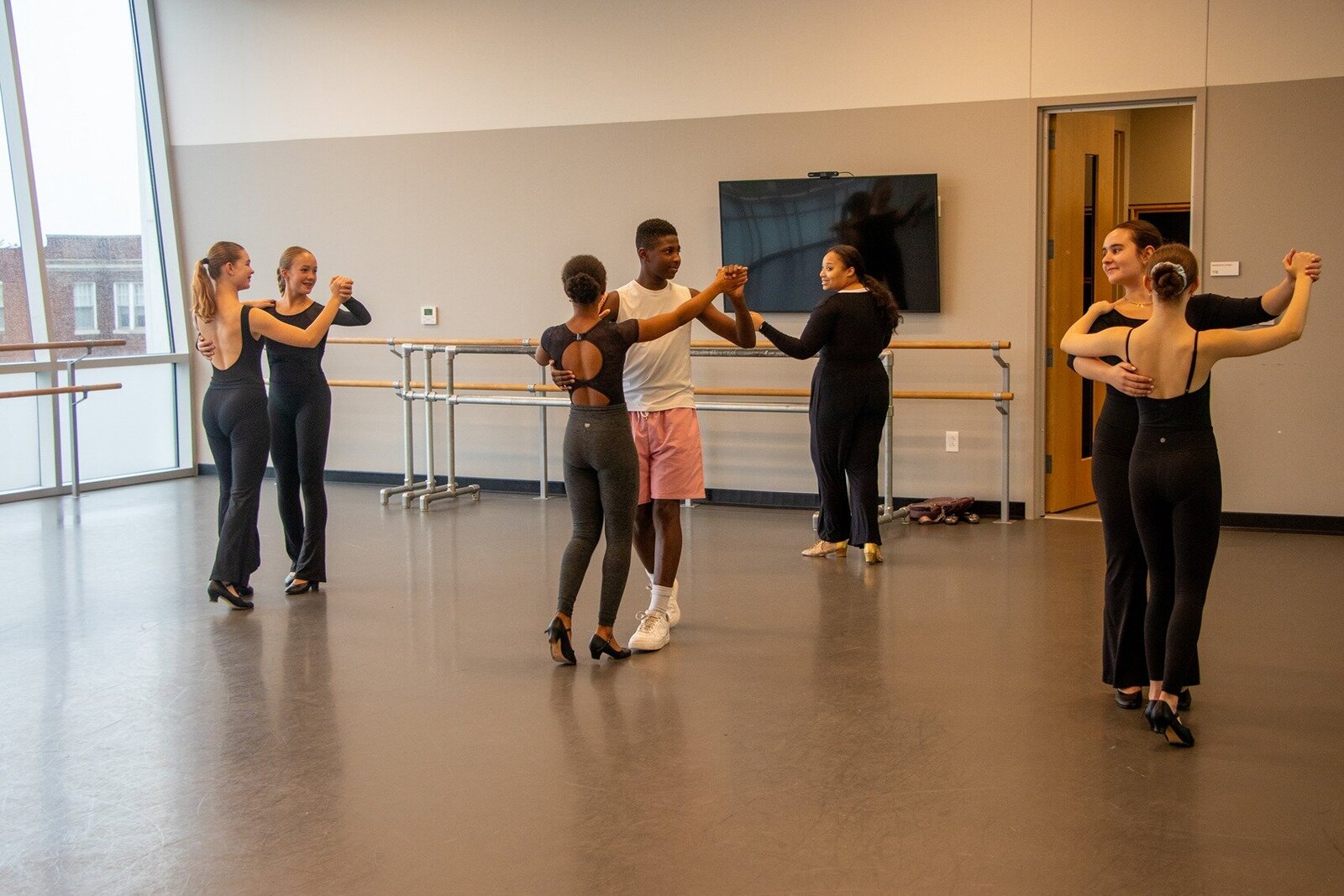 Group of kids learning to dance by coach Morgan