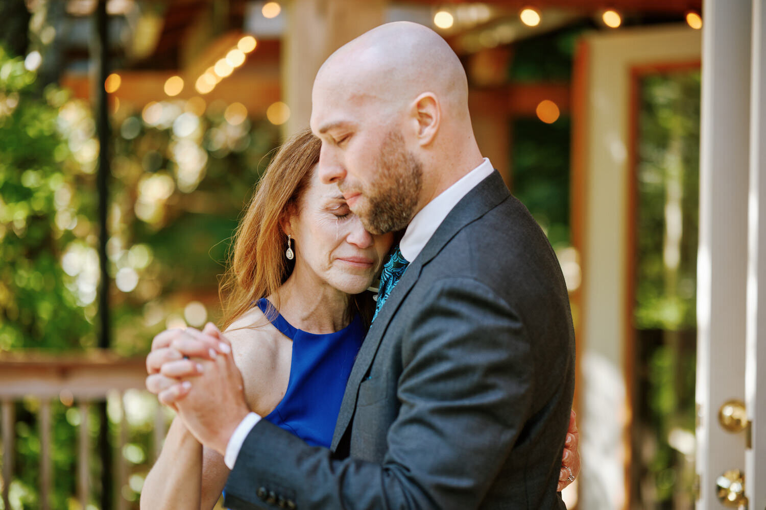 Mother of the groom  sheds a tear during the mother-son dance