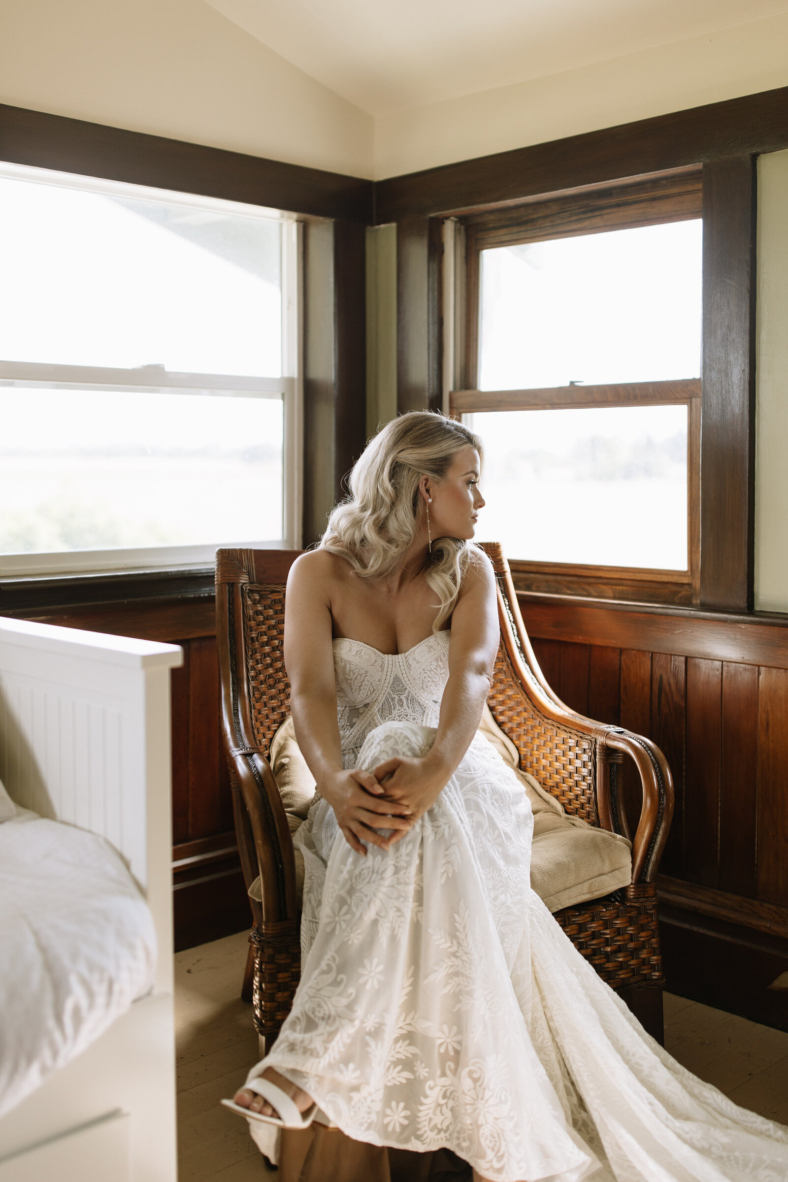 Bride poses in front of window by Idaho elopement photographer, Erica Rochelle
